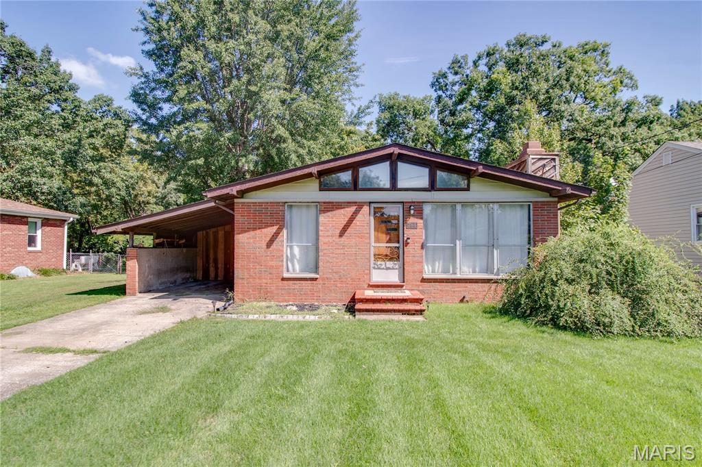 Welcome to 784 E Woodland Drive in Rosewood Heights, located in the desirable Roxana School District and situated on an impressive 60x200 lot! The inviting living room features tall ceilings, wood floors, large windows, and a gas fireplace that creates a warm and welcoming atmosphere. The dining area flows into the kitchen, which includes a gas range, microwave, and dishwasher. Three bedrooms feature wood flooring, while the remodeled full bathroom offers updated finishes. A bright sunroom provides additional living space and a wonderful spot to relax. Outside, the oversized yard offers plenty of space for entertaining, recreation, gardening, or simply enjoying the outdoors. A composite deck provides a great place to gather, while the concrete driveway, attached one-car carport, and separate workshop add convenience and functionality.
The full unfinished lower level provides excellent storage space and includes the laundry area. The entire sewer system was replaced in 2022, providing added peace of mind. With its sought-after school district, spacious lot, inviting interior, and desirable features, this Rosewood Heights home is ready to welcome its next owner!