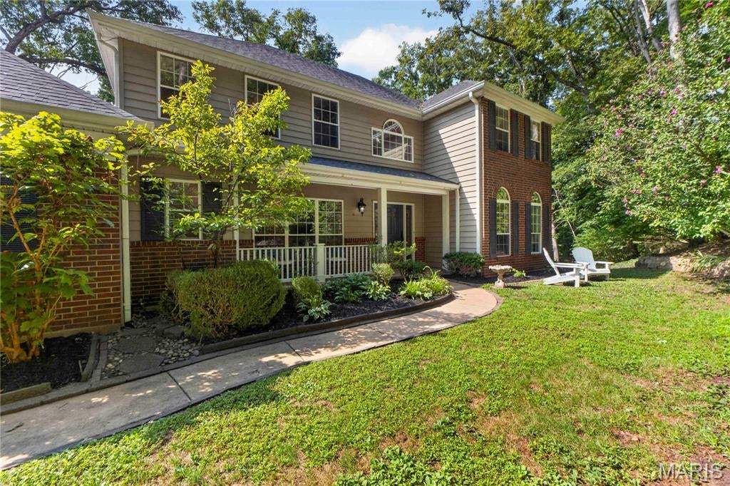 Private Wildwood retreat, tucked away in a peaceful wooded setting, while still ten minutes from Wildwood Town Center!
Set on 3.13 wooded acres, this beautiful brick-front two-story home offers a private, tree-lined setting with approximately 3,784 square feet for both quiet living and space for lively entertaining.
The main level features a welcoming great room with tree canopy views and hardwood flooring, a formal dining room, den, breakfast room, spacious kitchen, and a wood-burning fireplace, with hardwood carrying up the staircase. 
The expansive primary retreat offers a sitting area or reading nook, a large en suite bath, and a walk-in closet with exceptional storage.
The partially finished walk-out lower level features a family room and recreation room, with a fire pit area just outside for evenings beneath the trees. The low-maintenance composite deck, screened by mature trees, is an ideal spot for morning coffee or evening entertaining. 
A 3-car oversized garage and a location within the desirable Rockwood School District complete this exceptional property, offering a private retreat while staying connected to everyday amenities.
