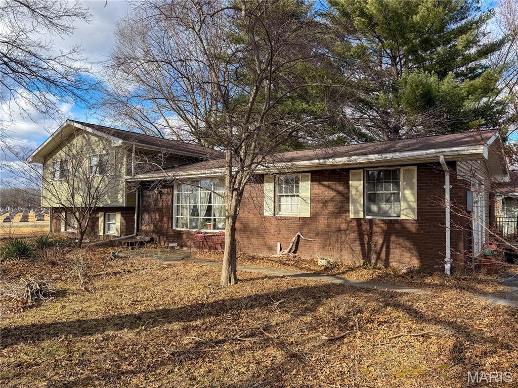 The best of both worlds — quiet country living at the edge of town, just minutes from I-55. This 3-bedroom, 2-bath home sits on a .79-acre lot filled with mature trees and a shady, park-like yard. Inside, you’ll find spacious rooms, a whole-house fan, some newer flooring, and a large atrium door with transom that fills the home with natural light. The lower level features an updated bathroom, a cozy family room with a wood-burning fireplace, and an oversized great room off the kitchen. Enjoy morning coffee or evening downtime in the enclosed three-season room with easy access to the fenced backyard. Schedule your private showing today. Pictures are from the previous listing in 2019