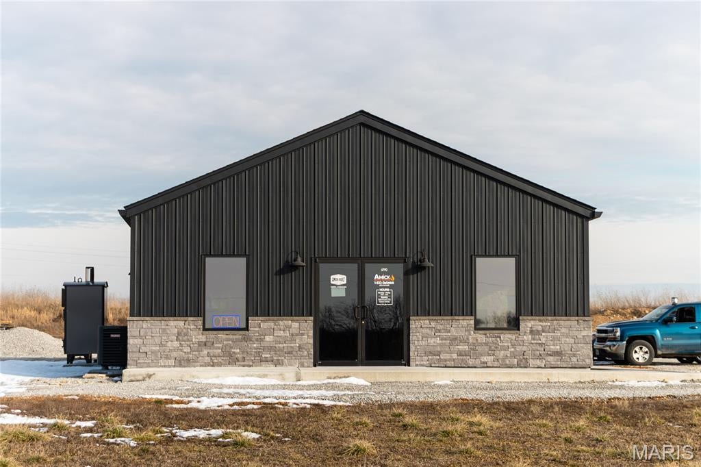 Newly constructed in 2024, this 30 x 48 (1,448 sq ft) commercial building offers an excellent opportunity for your business. The layout features a dedicated reception and office area in the front, with a versatile shop space in the rear that includes a garage door and can be customized to meet your needs. The property includes one restroom and 10-foot ceilings throughout. Ideally positioned with Highway 63 frontage on the west and access from Millstone Road on the east, the site also features an access road along the western boundary and a fire hydrant located at the property entrance. Zoned Highway Business District, this location is well-suited for a variety of commercial uses.