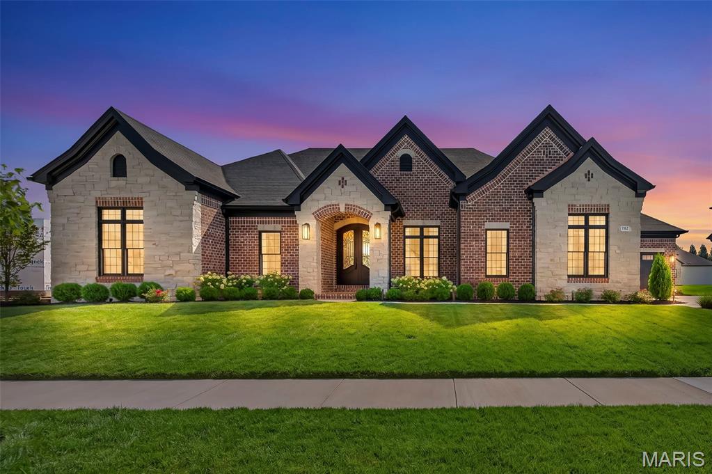 Welcome to this extraordinary luxury residence less than one year old! This home has been thoughtfully designed with sophisticated finishes, exceptional craftsmanship, and an impressive array of indoor and outdoor amenities. Offering 4 bedrooms, 3 full baths, and 2 powder rooms, this home delivers spacious, comfortable living with attention to every detail.

The impressive 12-foot entry and great room ceilings create a dramatic first impression, while 10-foot ceilings throughout the remainder of the main level and 10-foot pour in the lower level add to the home’s expansive feel. Elegant 8-foot doors, crown molding, 7½-inch baseboards, and engineered 7¼-inch hardwood flooring are showcased throughout.

The luxurious primary suite is a private retreat featuring a stunning bath with a large walk-in shower, freestanding soaking tub, and his-and-her walk-in closets. Two secondary bedrooms each feature their own attached full bath, providing exceptional privacy and convenience.

The heart of the home is the spectacular great room, highlighted by a beautiful fireplace with custom built-ins. A separate vaulted hearth room offers an inviting space to relax beside a striking stone fireplace. The gourmet kitchen features stacked cabinetry, 6 burner gas stove, double wall ovens, 48" built in side by side refrigerator, microwave drawer, complemented by a spacious butler’s pantry for additional storage and entertaining ease. A thoughtfully designed drop zone with built-in lockers keeps everyday life organized.

The private den showcases custom built-ins and elegant wall molding, creating an ideal home office, library, or quiet retreat. 

The finished lower level takes entertaining to another level, featuring a built-in golf simulator and wet bar, creating the ultimate destination for game days, gatherings, and recreation.

Outdoor living is equally impressive with a brick and stone covered porch, beautifully landscaped front and rear yards, an aluminum-fenced backyard, irrigation system, and landscape lighting. The exterior combines timeless brick and stone with durable Diamond Kote siding for exceptional curb appeal and lasting beauty.

A spacious 4-car garage provides abundant space for vehicles, storage, and recreational equipment.

Every element of this remarkable home has been carefully selected to create a truly elevated living experience—where luxury, functionality, and timeless design come together beautifully. Make your appointment today!

See agent coments for list of inclusions