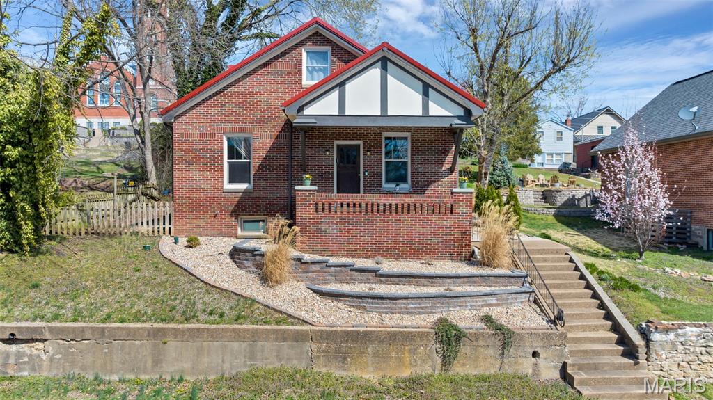 Welcome to the enchanting charm of Historic Hermann, MO! This adorable 1923 brick cottage is perfectly situated just 1.5 blocks from downtown boutiques, restaurants, wineries, and breweries, offering the ideal blend of small-town charm and walkable convenience.



Full of character, this bungalow-style home showcases beautiful original wood floors and stunning trim that highlight its timeless craftsmanship. The main level offers comfortable living with a spacious living room, separate dining area, well-sized kitchen, bedroom, and full bathroom.



Upstairs, you’ll find a generous loft area, a second bedroom, and an additional bathroom complete with a separate tub—perfect for guests, a cozy retreat, or flexible living space.



Enjoy peaceful mornings on the large covered front porch and unwind in the evening on the covered back porch overlooking the spacious backyard. The backyard is already set up with a charming firepit area, ideal for relaxing nights by the fire with a glass of local Hermann wine while taking in the picturesque views.



Additional highlights include a dual-zoned heating and cooling system for year-round comfort and R1 Residential zoning. Contact the City of Hermann for details on potential Bed & Breakfast use (short-term rentals/Airbnb not permitted).



This storybook cottage offers historic charm, modern comfort, and an unbeatable location in the heart of Hermann.