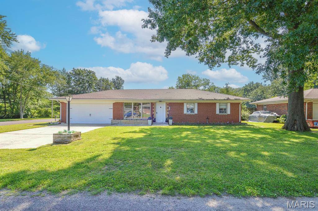 Beautifully maintained and lovingly cared for, this 3BR/1BA solid brick ranch home with an attached garage and full, partially finished basement is situated on a 0.25± acre corner lot in the highly desirable Stauder Subdivision in Belleville. The spacious living room is flooded with natural light from large front-facing windows and showcases beautifully restored hardwood flooring underfoot. Just off the living room, a formal dining area adjoins the cozy kitchen featuring a convenient breakfast bar for casual dining. The main hallway leads to the generously sized primary bedroom as well as the two remaining bedrooms and a well-appointed full bathroom. A mudroom located off the dining area provides access to the attached single-car garage and workshop space. The full, partially finished basement is accessed through the garage and offers a large, carpeted recreation area, ideal for entertaining, hobbies, or additional living space. Also available is an unfinished utility room for storage and mechanicals. The home has been professionally waterproofed by Foundation Recovery Systems, with a transferable warranty that will convey to the new owner. Plumbing and ventilation are also in place for a washer and dryer; however, the connections will need to be reconnected by the new owner. Outside, the large partially fenced backyard features a poured concrete patio and plenty of room to create the outdoor space you’ve envisioned. The corner lot provides additional yard space and flexibility for landscaping, gardening, or recreation. Conveniently located near local schools, IL Route 15, shopping, dining, and just minutes from the historic Belleville Public Square, this move-in-ready home offers comfort, character, and an excellent location.