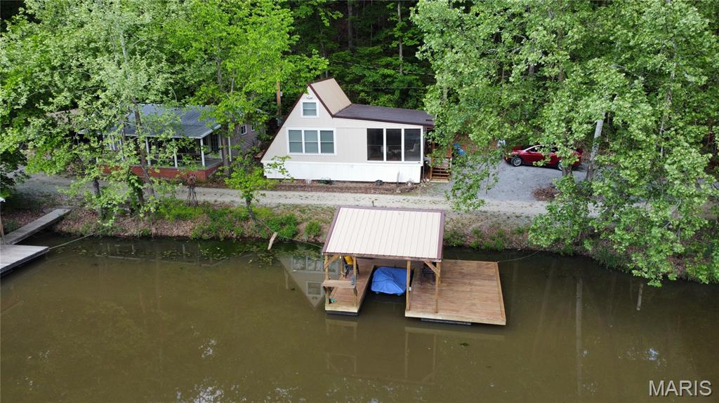 Waterfront Retreat with Private Dock – The Perfect Lake Getaway!

Escape to your own slice of paradise with this charming A-frame cabin with a loft sleeping area on the upper floor. 3 full beds can fit up there and sleep 6. Beautiful lakefront property just minutes from Fulton. Whether you’re looking for a peaceful weekend retreat or a cozy year-round escape, this property delivers the ultimate waterfront lifestyle.

Enjoy morning coffee or evening sunsets from the spacious 24x12 screened-in porch—complete with a convenient storage closet for all your fishing gear and lake essentials. The private dock, featuring a brand-new roof, makes boating, fishing, and swimming right off your property effortless and enjoyable.

Inside, the open-concept floor plan offers a warm and inviting living space, with expansive windows that frame stunning lake views and overlook the dock area. The main bathroom is located on the main floor for added convenience, while the loft bedroom provides a cozy, cabin-style retreat.

Offered mostly furnished, this move-in-ready lakefront gem is ready for you to start making memories from day one.

Don’t miss this opportunity to own your own waterfront getaway!