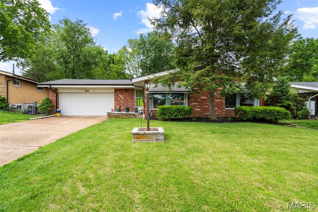 Are you looking for a house so cool, even your coolest friends are jealous? This Mid-Century Modern home is it! Tastefully updated while maintaining that 1960s swagger throughout. Original front door, wood paneling, moldings, etc. Vaulted living room with full brick fireplace, separate dining and sprawling windows. Renovated eat-in kitchen with stainless appliances, center island and tons of space for hosting. Circular basement bar for swanky parties. What's not to love?! 3 main level bedrooms, including an ensuite primary full bath, a full hall bath, and a half bath in the basement provides room for the whole family. The finished basement with projector screen, playroom, and secondary kitchen setup let's you spread out and entertain all ages in comfort. Out back is a large patio and fully fenced yard with plenty of space for pets and kids (or kids at heart) to run around. 2 car attached garage. New roof installed 2024. New HVAC installed 2023. This home has been lovingly cared for, and won't last long, so schedule your showing ASAP!