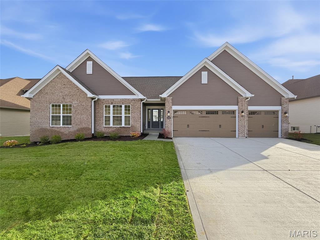 Move In Ready! New home construction in the picturesque Windsor Park neighborhood in Lake St. Louis by Fischer and Frichtel!  This popular Durham ll ranch offers 3 bedrooms, 2.5 bathrooms, 2,211 square feet of open living space and a walkout lower level!  The exterior is impressive with a partial brick facade, vinyl siding, 3 car garage, carriage style garage doors, coach lights, garage door opener, architectural shingles, landscaping, full yard sod and lawn irrigation. Luxury features include 9 foot ceilings with 12 foot in the Great Room, dynamic window wall in the Great Room, on-trend gourmet kitchen, 42 inch cabinets with crown and honey bronze hardware, custom cabinetry features, soft close doors and drawers, Kitchen island with seating bar, wall ovens, 5 burner gas cooktop, chimney range hood, quartz countertops, tile backsplash, stainless steel appliances, walk in pantry, Luxury Vinyl Plank flooring, electric fireplace, Low E windows, Spa Primary Bath, marble shower with seat, raised height double bowl vanities, walk in closet, patio, 50 gallon water heater, main floor laundry, main floor Powder Room, walkout basement, rough in bath and so much more.  There is easy access to Highways 70,40 and 364.  Students will attend desirable Wentzville schools.  This lovely neighborhood has 2 scenic lakes, abundant common ground and a picnic area with pavilion. Make it yours!