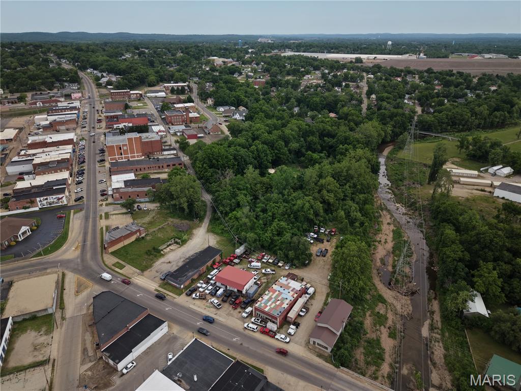 Positioned along a high-traffic corridor, this 1.3± acre commercial property presents an outstanding development opportunity with prime West Main Street frontage. Offering exceptional visibility and steady traffic exposure, the site is well-suited for a wide range of commercial ventures. The front portion of the property features direct access and prominent frontage along W. Main Street, ideal for retail, office, or service-based businesses seeking maximum exposure, as well as frontage on Haney St. to the north. Beyond, the property extends into a larger, wooded rear section, providing valuable space for expansion, additional structures, off-street access, or generous parking accommodations. With its flexible layout and potential for subdivision, this property offers investors and developers the ability to maximize usability and long-term value in a highly desirable location.