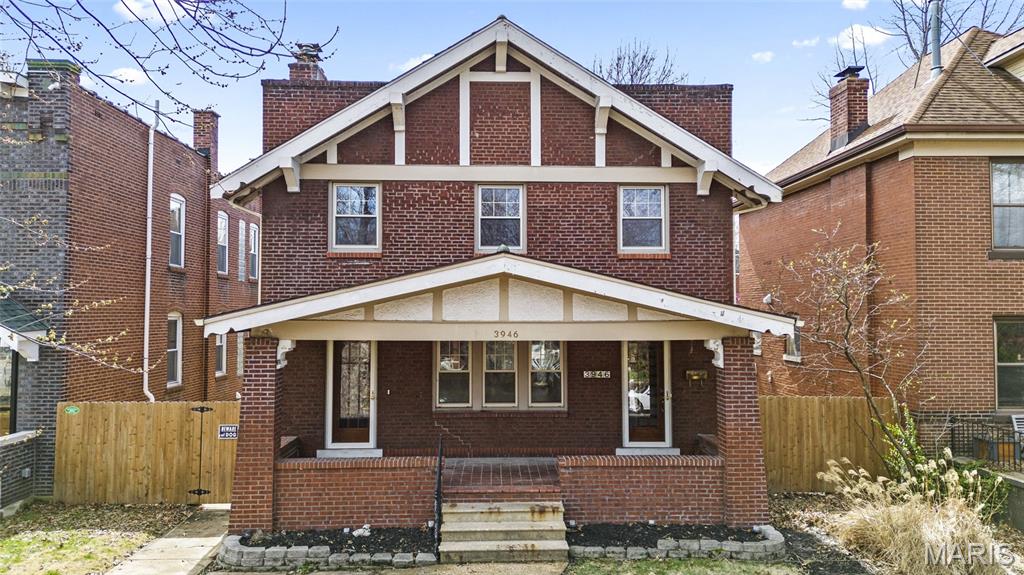 This large, beautiful brick home offers a perfect blend of classic charm and modern convenience. A welcoming covered front porch invites you in, perfect for relaxing or greeting neighbors. The kitchen features a bright breakfast nook and a spacious butler’s pantry, ideal for meal prep and entertaining. The living room is warm and inviting with a wood-burning fireplace and gorgeous wood floors. Natural light floods the home through light, bright spaces accentuated by charming stained glass windows throughout. Upstairs, the master suite includes a luxurious bath and a sunny porch, creating a peaceful retreat. All bedrooms are generously sized, offering comfort and flexibility for family or guests. Outside, enjoy a double lot with a fenced yard, a large deck, and ample space for outdoor activities. The home includes a 2-car garage and is perfectly situated for excellent walkability and city living. This property combines elegance, space, and location for the ideal urban lifestyle.