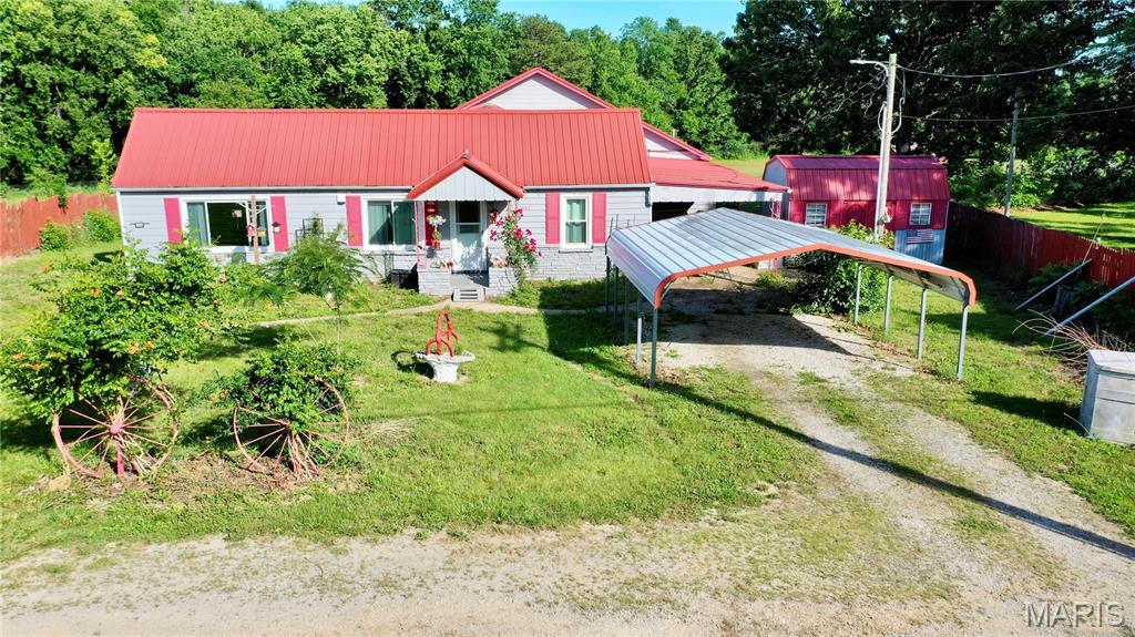 Just outside of Salem and situated on 2.80 acres this home offers plenty of room for your family as there are 5 bedrooms and 3 baths.   Kitchen has wood cabinets, stainless, bottom drawer refrigerator, dishwasher new in 2026 and electric range. Separate dining area. Main BR has sliding doors out to 40' x 10' deck w/pretty view of the pasture & barn. Laundry room and a storage room.  Natural gas heat, central air, 8 ceiling fans and attic fan. Attached carport & 18' x 20' detached carport. Drilled well and septic. Neat barn w/17' x 18' room & attached 11' x 18' & 12' x 18' lean-tos. Large garden area. Property is partially fenced & would be great for a few horses or calves. No restrictions. Blue outbuilding is not included. Call today for a showing!