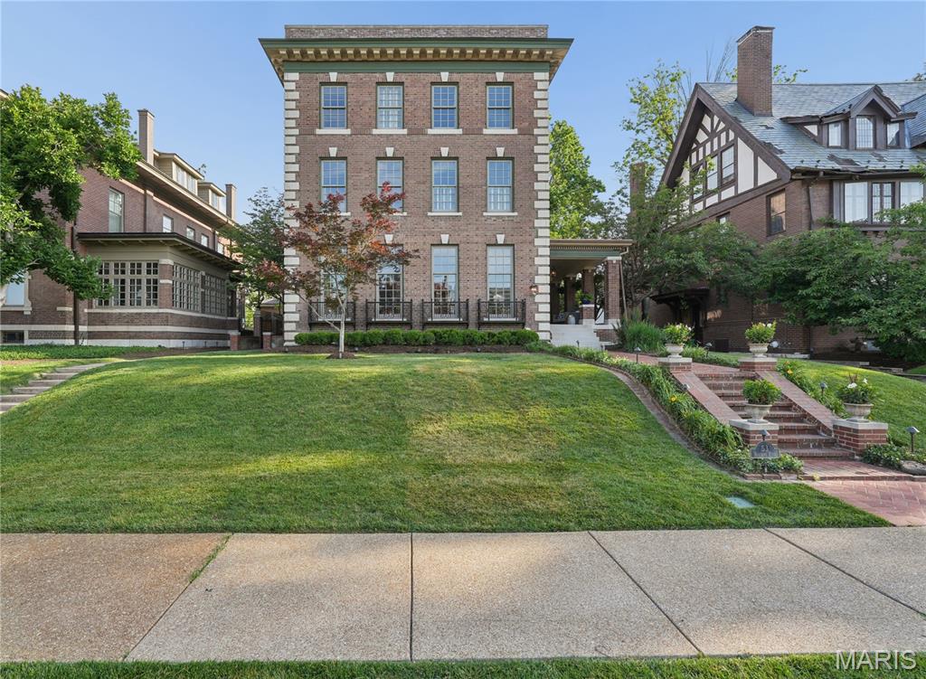 A timeless turn-of-the-century Georgian Federal Revival, this architecturally significant residence—once home to Rolla Wells (then mayor of the 1904 World’s Fair)—has been masterfully restored and renovated across three exceptional levels in one of St. Louis’ most coveted neighborhoods. Restored to its original grandeur with decadent updates, the distinguished all-brick home seamlessly combines contemporary conveniences with immaculate historic architecture, showcasing exquisite period millwork, refinished hardwood floors, stained glass, soaring 10- and 9-foot ceilings, plantation shutters, and seven fireplaces throughout. Designed for both refined everyday living and elegant entertaining, the gourmet kitchen is appointed with Viking and Sub-Zero stainless steel appliances, a walk-in pantry, vegetable sink, wine storage, and a sunlit breakfast room featuring custom built-ins and dramatic floor-to-ceiling windows. The luxurious primary suite offers a multi-tray ceiling, boutique-style dressing room with custom cabinetry and center island, & a spa-inspired bath with a curved glass shower. Additional second-level accommodations include a spacious en-suite bedroom with sitting room, private office, and second-floor laundry. The versatile third level offers two additional oversized bedrooms plus an expansive bonus bedroom or recreation space. Above the detached four-car garage—finished with durable PebbleTec flooring—is an additional 924-square-foot guest residence complete with skylights, kitchen, laundry, bedroom, and full bath, ideal for extended stays, private guest quarters, or au pair accommodations. Set on a beautifully landscaped and level .35-acre lot with a deck, patio, and mature gardens, the grounds provide ample space for a future pool. Ideally situated near Forest Park, the St. Louis Zoo, premier hospitals, Clayton, fine dining, shopping, and major highways, this is a rare opportunity to own a truly exceptional home in one of St. Louis’ most prestigious settings.