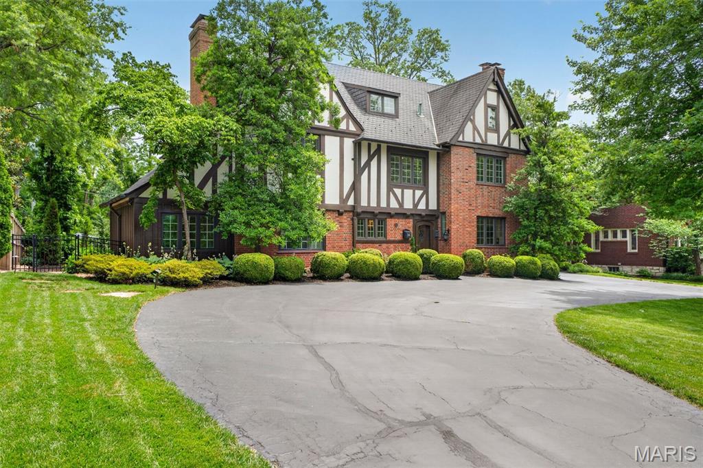A 1925 Study & Farrar Tudor among the founding residences of Claverach Park, the Pitzman-planned garden suburb listed on the National Register of Historic Places. A century old and beautifully kept, it pairs original character with thoroughly updated systems.

An arched entry and leaded glass open to a turning staircase, oak floors, and original millwork. The living room centers on a carved mantel; the formal dining room’s bay window overlooks the garden and pool; the renovated kitchen pairs white cabinetry with Viking appliances and a sunlit breakfast room; and a beamed family room with a gas fireplace anchors everyday living.

The primary suite, created where the original plan had none, offers a marble bath with freestanding tub, glass shower, and twin vanities. Four bedrooms and five baths span 4,473 square feet, plus a flexible third-floor bonus room suited to a home office, guest suite, studio, or gym.

Behind the period character, the home has been thoroughly modernized: copper plumbing, updated 200-amp electrical, all baths rebuilt, a finished lower level, a whole-house generator, and heating and cooling updated in stages, most recently in 2025. Outside, nearly half an acre holds a private in-ground pool, custom gas fire pit, paver walkways, and an 11-zone irrigation system, backing to woodland.