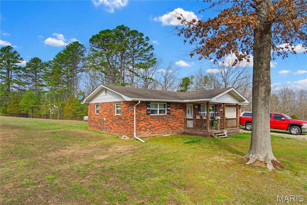 This all brick home is a 2 bedroom, 1 bath with attached 1 car garage with an all brick exterior sitting on 5 acres m/l.  The property has a 500 ft, drilled well that supplies the home and the 3 RV/Mobile home pads. which offer income potential.  The large yard and circle drive backs up to wooded acreage with tons of whitetail deer, turkey and other small game.  The location just 4 miles south of Ellington offers Hwy 21 frontage and is in close proximity to Clearwater lake, Black River, Current river, Miller lake, Big Springs State park and 1000's of acres of National Forests.  Whether looking for a homestead or an investment property, this Ozark beauty fits the bill.  Schedule your appointment today for a personal viewing of this magnificent property.