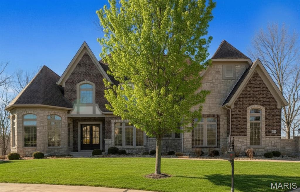 Prestigious homes in this highly coveted Chesterfield neighborhood rarely come to market, and this one is extraordinary. Nestled at the quiet end of a private cul-de-sac, 1401 Fox Hill Farms Court spans nearly 7,900 square feet of living space across 1.5 stories offering the rare combination of seclusion, sophistication, and effortless luxury that discerning buyers wait years to find.

Imagine waking each morning to panoramic views of rolling hills and mature woods. The main floor is thoughtfully crafted for both everyday living and grand entertaining, anchored by a chef's kitchen with an oversized island and sun-filled breakfast room that opens to a hearth room with a cozy fireplace. A gracious dining room, two half-baths, and a sophisticated wet bar make hosting effortless. For those who work from home, the main-floor office is a showstopper in its own right with soaring 12-foot ceilings and an abundance of natural light which make it as inspiring as it is functional. The primary suite completes the main level as a serene retreat, featuring coffered ceilings, built-ins, an oversized walk-in closet, spacious walk-in shower, soaking tub, and generous double vanities.

Upstairs, three private en-suite bedrooms each offer large walk-in closets with custom systems and the kind of thoughtful storage rarely found at this level. The fully finished walk-out lower level is a world unto itself complete with a private entrance, full in-law or guest suite, spacious family room, wet bar, wine cellar, and a 56' x 30' top-of-the-line gym that rivals any high-end facility. No membership required.

The home is equipped with a premium sound system as well as comprehensive home automation which can be controlled remotely, plus a backup generator for peace of mind. With five suites, seven baths, three fireplaces, a three-car garage, and nearly an acre of wooded privacy, this estate delivers on every level.

Beyond the front door, you're living in one of West County's most sought-after communities and tucked away from the bustle, yet minutes from Chesterfield's premier dining, shopping, and recreation. This is more than a home. It's a lifestyle.