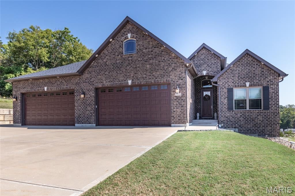 You don't often find a home with so much to offer! This 8-year-old ranch offers 4 bedrooms, 3.5 baths, nearly 2 acres, and an oversized 4-car garage. The main level features a 12' entry foyer, 9' ceilings, hardwood floors, and a vaulted great room with abundant windows overlooking the backyard. The gorgeous kitchen boasts custom cabinetry, granite countertops, a large island, and stainless steel appliances. The dining room offers a 12' slider to the patio. Main-floor laundry and a spacious primary suite with walk-in closet and large shower add convenience. Two additional bedrooms complete the main level.
The 9' pour walk-out basement includes a 4th bedroom, rec/family room, wet bar, home gym with mirrors, and plenty of unfinished storage. Additional features include dual-zone heating and cooling, whole-house water filtration, and a tankless water heater. The heated garage features a 13' ceiling, 9' insulated doors, hot/cold water faucet, and space for up to 6 vehicles. The attic offers electric, lighting, windows, extra insulation. The exterior has can lights in the soffits and outlets in the eaves. Plenty of parking outside including space for an RV. So much space, quality, and versatility—this home truly has it all!