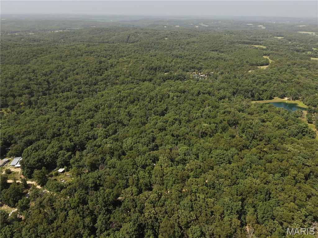 Discover 7.42+/- acres of unrestricted land in Franklin County located off Gibson Road, offering the privacy and flexibility to enjoy the property your way. A gated entrance welcomes you onto a rolling, timbered landscape filled with mature hardwoods, creating a secluded setting for recreation, camping, a weekend retreat, or a future homesite. The property includes a small two story cabin shell with a loft, stairs, rough-in plumbing and electrical, as well as a deck that provides an excellent base camp while enjoying the land. A fenced area with woven wire is already in place, making it well-suited for small livestock, dogs, or other animals. Electric is available nearby along with an old well house and well providing added convenience for future improvements. Whether you're looking for a hunting property, a private getaway, or a place to build without the limitations of an HOA or restrictive covenants in the Londell School District, this tract offers plenty of possibilities. Large mature timber, rolling wooded terrain, and a peaceful setting combine to create a property that's increasingly difficult to find in Franklin County. Owner Financing is available.