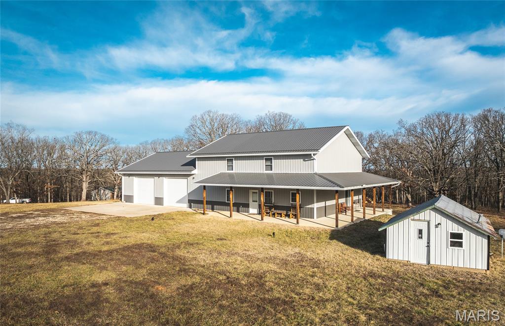 Discover the perfect blend of charm and wide-open space with this exceptional 68+ acre property just South of the Osage River, Tuscumbia in the heart of Miller County, Missouri. Nestled among rolling acreage, this beautiful 2650 sq ft, 2-bedroom, 2-bath lodge offers the ideal setting for a private retreat, hunting getaway, or full-time country living. The 1440 sq ft oversized garage features two overhead doors and shop sink.
The lodge features warm wood siding and an expansive, open living area highlighted by soaring ceilings and a generous loft that overlooks the main living space. At the center of the home is a striking floor-to-ceiling wood fireplace, creating a cozy focal point for gatherings in every season. Large windows invite natural light and showcase peaceful views of the surrounding land. The wrap around covered porch is perfect for morning coffee or evening night caps.
Both bedrooms provide comfortable accommodations, while two full bathrooms add convenience for family and guests. Additional bedrooms could be framed in on the loft if needed and plumbing has been run for an additional bathroom on the upper level. The open layout is perfect for entertaining, relaxing after a day outdoors, or simply enjoying the quiet beauty of nature.
The 68+ acres offer endless possibilities—whether you’re looking for recreational land, hunting opportunities, farming potential, or a secluded escape. With ample room to roam, explore, and enjoy Missouri’s outdoors, this property is a rare find. Located only a short drive from Jefferson City, Lake of the Ozark and Osage Beach.
