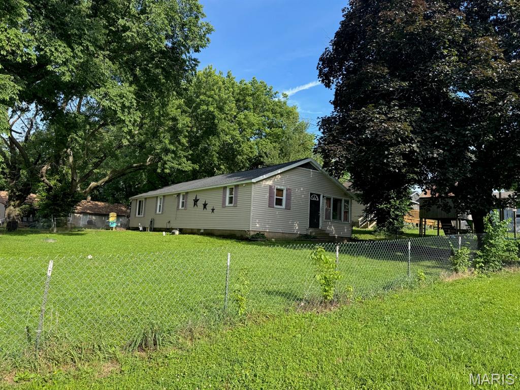 This 3 bedroom 2 bath home sitting on a large lot at the edge of town outside the city limits. It has a partially fenced yard The extra room could be used as a bedroom, family room, play room .or office. The master bedroom bathroom has a nice walk-in shower. The large dining room is great for family gathering. Updates include, roof  2026, furnace 2026, aerator septic 2019, blown insulation. The carport has a small  workshop area. Nice covered patio to sitting outside  Make your  appt to see