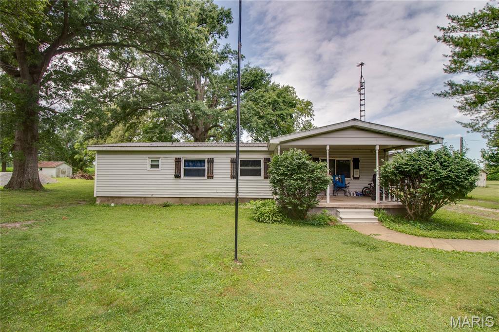 Well-maintained ranch-style home offering comfortable one-level living with plenty of garage and workshop space. The exterior features low-maintenance vinyl siding, a durable metal roof on both the home and garage, central air conditioning, a covered front porch, concrete patio, gravel and grass driveway, and an 18' x 12' detached metal storage shed. Inside, you'll find a spacious  living room a large eat-in kitchen, providing plenty of room for gatherings. The convenient  mudroom/laundry room offers direct access to the backyard and patio. The main level includes three bedrooms, including a primary suite with a private 3/4 bath featuring a step-in shower with built-in bench seat. Two additional bedrooms, a full bath, and ample storage complete the floor plan. A standout feature of this property is the detached garage setup, offering space for up to three vehicles. There is an additional one car garage  with its own sliding-door entrance, making it ideal for hobbyists, storage, or additional workspace. This move-in-ready property combines practical amenities, generous storage, and easy main-floor living, making it a great place to call home.