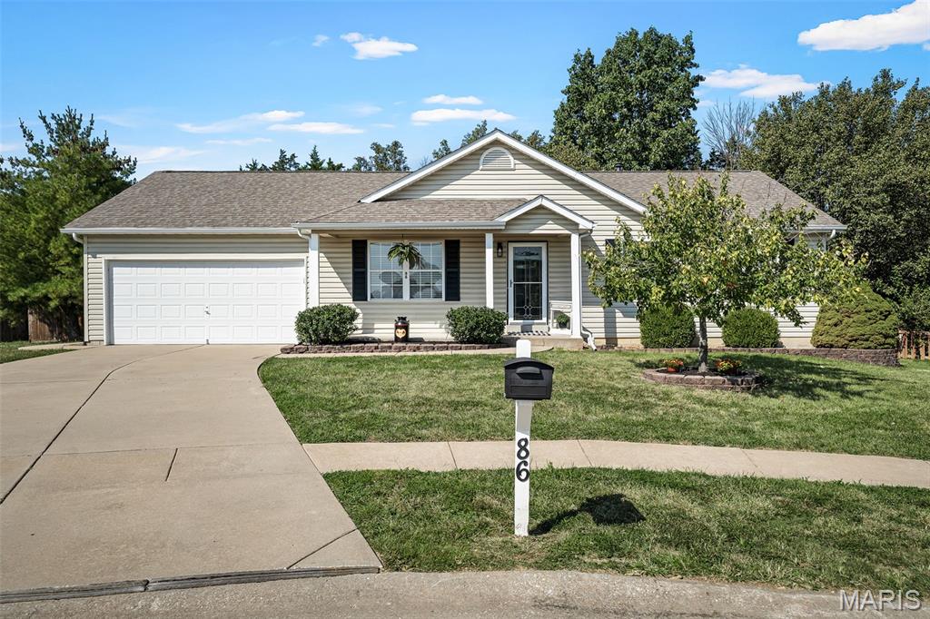 Welcome home to 86 Sunhaven Court, a warm and inviting ranch nestled on a nearly half acre lot in a cul-de-sac. Fresh paint and brand-new flooring throughout create a bright, comfortable feel, while main-floor laundry adds everyday convenience. The finished lower level provides additional room to spread out, complete with a full bathroom and flexible space ready to fit your needs. Situated on a beautiful 0.47-acre lot, the home is surrounded by mature trees and offers a spacious backyard perfect for play, gatherings, or peaceful evenings beneath the covered patio. Just minutes from I-70 and 40/61! Start your mornings with coffee on the covered front porch, and enjoy the added parking and storage provided by the oversized garage. With comfortable living spaces, thoughtful updates, and plenty of room to make lasting memories, this home is ready for its next chapter.