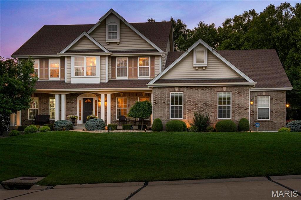 Welcome to 9031 Spy Glass Place Drive, an exceptional custom 1.5-story home complete with an oversized 3 car side entry garage, tucked away on a homesite in the prestigious Spy Glass Hill at Winghaven. Thoughtfully designed with timeless architecture, refined finishes, and expansive living spaces, this stunning home offers 4 bedrooms, 3.5 bathrooms and an outdoor oasis. The gourmet Chef's Kitchen is designed to inspire both everyday living and effortless entertaining. Custom cabinetry is complemented by granite countertops, decorative tile backsplash, premium stainless steel appliances, a gas range and an oversized center island. A butler's pantry provides additional prep and serving space, while the built-in planning desk offers the perfect command center. Just beyond the kitchen, the Breakfast Nook and sun-filled Hearth Room,  surrounded by windows, capture the peaceful backyard views. The Great Room creates an unforgettable first impression with its wall of windows, custom built-in bookcases, and elegant fireplace. This space offers the perfect balance of sophistication and comfort while showcasing the landscaped yard. The main-level Primary Suite is a private sanctuary complemented by a custom walk-in closet system and a spa-inspired luxury bath. The updated bathroom features a freestanding soaking tub, an oversized walk-in tile shower, dual granite-topped vanities, designer lighting, and an elegant decorative tile backsplash. A private suite on the upper level features its own en-suite bath and designer walk-in closet, while Bedroom #3 and #4 share a spacious Jack-and-Jill bathroom, offering comfort and privacy. The Loft/Bonus Room offers flexible recreation space. Outdoor living is equally impressive. Step onto the patio overlooking a beautifully landscaped backyard complete with a tranquil waterfall/pond, inviting firepit, and a canopy of mature trees that provide exceptional privacy and a peaceful setting. This home is just minutes from the exclusive WingHaven Country Club, where residents have the opportunity to enjoy private golf and social memberships. Experience championship golf at a Jack Nicklaus designed golf course, exceptional dining, resort-style swimming, tennis, pickleball, fitness amenities, and social events—all just minutes away. With its exceptional craftsmanship, thoughtfully designed floor plan, luxurious finishes, and ideal location, this remarkable home delivers the perfect blend of elegance, comfort, and everyday livability. Learn more about the lifestyle at Winghaven Country Club-https://www.winghavencc.com.