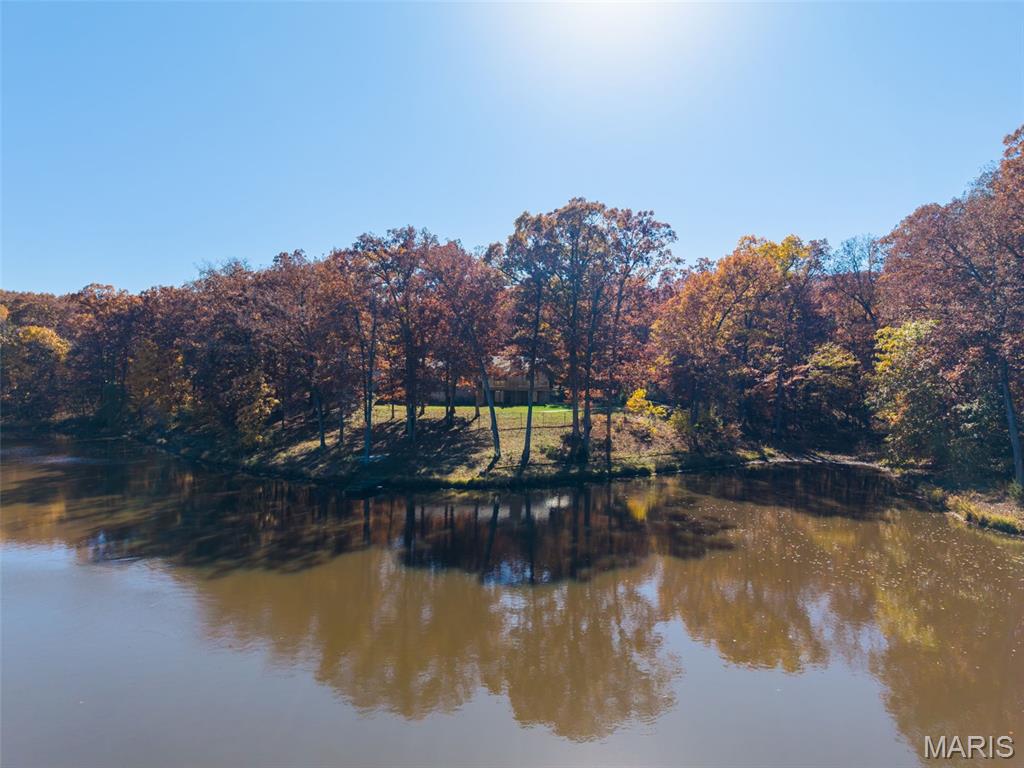 Motivated Seller. Welcome to Your Missouri Escape.
Discover the perfect blend of comfort, recreation, and serenity at 32342 Monroe Road 344, Hunnewell, MO. This all-brick 3-bedroom, 3-bath ranch home rests on 40 m/l; acres of rolling countryside, where mornings begin with coffee on the deck and end with sunsets over your own private lake.
Inside, an open floor plan connects the spacious living room, dining area, and a well-appointed kitchen, ideal for gathering with family and friends. The main floor also offers everyday ease with a laundry room, guest bedroom, and a relaxing primary suite featuring a walk-in closet and walk-in shower.
Step onto the expansive 32’ x 14’ deck to take in peaceful lake views and the sounds of nature , the perfect setting for grilling, entertaining, or simply unwinding.
The finished walkout lower level expands your living space with a warm, inviting family room featuring a brick wood-burning fireplace that helps heat the whole house, kitchenette, office, and guest bedroom....ideal for extended family or weekend guests.
For hobbyists and outdoor enthusiasts, storage abounds with an attached oversized 2-car garage, a 30’x24’ three-sided shed, and a 40’x30’ outbuilding ready for boats, ATVs, or projects. Outdoor garden area by the out building has its on water source.
Here, every day feels like a getaway. Spend quiet mornings fishing your stocked lake, afternoons spotting eagles, deer and turkey, or walking the several trails that wind through the property. Then on the weekends you could spend time exploring the Mark Twain Lake area that is just minutes away...where boating, hiking, and local wineries await.
Whether you’re seeking a peaceful full-time residence or a weekend retreat, this property invites you to slow down, spread out, and savor Missouri’s best outdoor lifestyle.
BUT WAIT there's more.......Furnace & AC 2021, Roof & Gutters 2024, Decking boards & railing 2025, Fireplace rebuilt 2021, both refrigerators stay.  Property also includes a drybed creek that when it rains runs to the lake.
