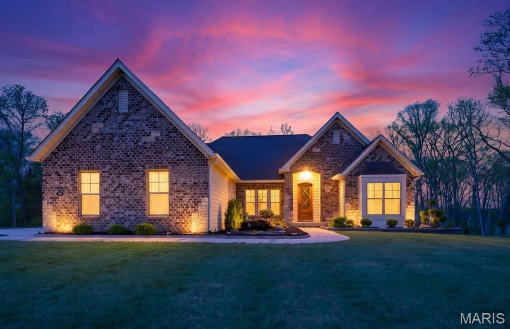 Welcome to 150 Del Creek Crossing—are you ready for an exceptional living experience? This custom-built home has been barely lived in and showcases thoughtful craftsmanship at every turn. Every corner features a custom touch you’re sure to fall in love with.

The open floor plan offers sophisticated interior detailing and upscale appointments throughout. As you approach the home, you’ll immediately notice the peaceful, relaxing setting, complete with the tranquil sounds of water flowing across the pond’s rocks. Step through the custom front door and you’re welcomed by warm hardwood floors that flow beautifully throughout the main living spaces. Just off the entry, a private office provides the perfect space to work or unwind away from the main living areas.

The elegant dining room greets you with style and functionality. As you move into the great room, stunning wood ceiling beams highlight the exceptional craftsmanship of the home. The designer kitchen is a true centerpiece, featuring custom cabinetry, quartz countertops, stainless steel appliances, and a large center island ideal for gathering. The hearth room fireplace creates a warm, inviting space to enjoy while cooking or transitioning to the deck.

The primary suite offers a true retreat, with ample space to relax, along with a freestanding tub and walk-in shower. On the opposite side of the home, two additional bedrooms and a full bath provide comfort and convenience for family or guests.

The finished lower level is designed for both entertainment and leisure. It includes a well-appointed kitchen area with a wet bar, two custom under-counter refrigerators, a microwave, and plenty of space to dine, play, and unwind. An additional bedroom features peaceful wooded views and access to a beautifully finished bathroom.

With minimal prior occupancy, this home feels nearly new and offers all the modern features you’re looking for—located within the highly sought-after Wentzville School District.

Let’s make this dream home your reality.