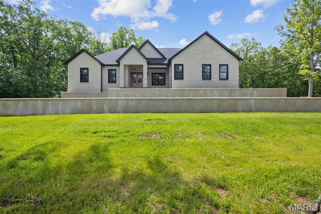 Experience the ultimate blend of country privacy, modern luxury, and state-park-like natural beauty! Situated on 11.16 private acres just outside Potosi city limits with no city restrictions, this property boasts approximately 600 feet of crystal-clear, year-round Bates Creek frontage. A scenic walk through beautiful mature timber leads down to a large, flat creekside oasis that feels like a private state park. Plus, with multiple building sites featuring electric access and a freshly cleared 0.25-acre pad, it’s turnkey for adding an outbuilding, shop, or additional home. The brand-new custom 2,200 sq. ft. ranch shines with a custom limestone facade and a light-filled, open-concept layout centered around a limestone fireplace. The gourmet kitchen features custom cabinetry, premium KitchenAid appliances, and sleek quartz countertops with a matching quartz backsplash. Unwind in the massive primary suite offering an expansive walk-in closet and a spa-like bath with a custom walk-in shower. Expand your living space in the full walk-out basement, already framed and plumbed for a 3rd bath. Complete with an attached 2-car garage and located minutes from Mark Twain National Forest, Huzzah Valley Resort, and YMCA Trout Lodge!