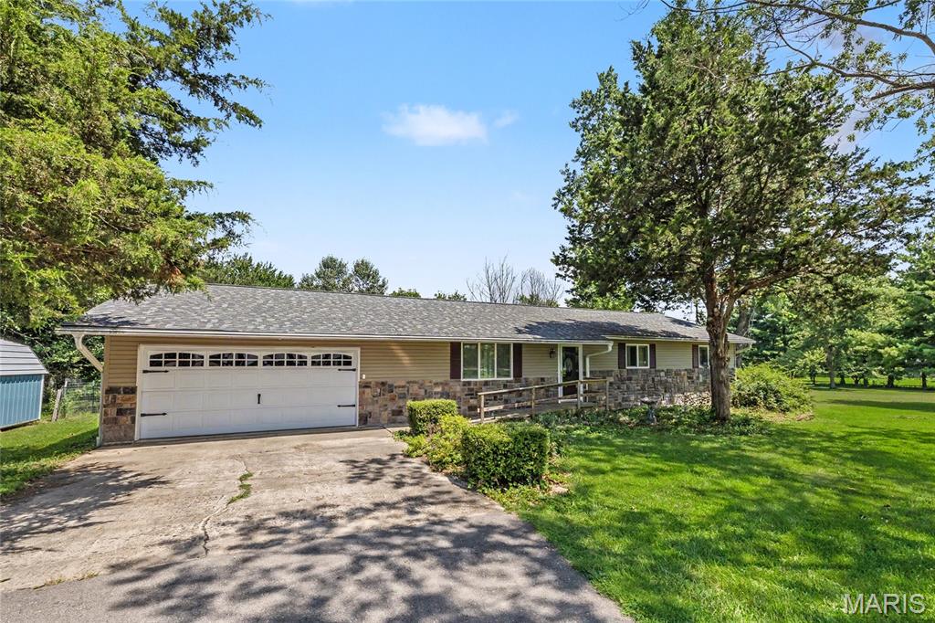 Discover the perfect blend of peaceful country living and modern comfort in this beautifully maintained 3-bedroom, 2-bath home nestled on 2.5 picturesque acres. Surrounded by mature apple and peach trees, this property offers a private retreat where you can enjoy the beauty of every season while still having all the conveniences of home. Step inside to an inviting open floor plan designed for everyday living and effortless entertaining. The spacious kitchen is the heart of the home, featuring a large island with a breakfast bar, stainless steel appliances, and plenty of room to gather with family and friends. The washer, dryer, and even the living room TV will stay with the home, making your move even easier. One of the home's most memorable features is the stunning fireplace, accented with authentic arrowheads that add a unique touch of character you won't find anywhere else. Outside, you'll love spending evenings on the huge covered back deck overlooking the fenced backyard, perfect for pets, play, or simply relaxing in the fresh air. Two storage sheds, a chicken coop, and ample outdoor space offer endless possibilities for gardening, hobbies, or creating your own mini homestead. Major updates, including a new roof in 2019 and a freshly paved driveway in 2024, provide added peace of mind. If you've been searching for a home that combines charm, acreage, and thoughtful updates, this one is a must-see. Schedule your private showing today and experience everything this exceptional property has to offer!