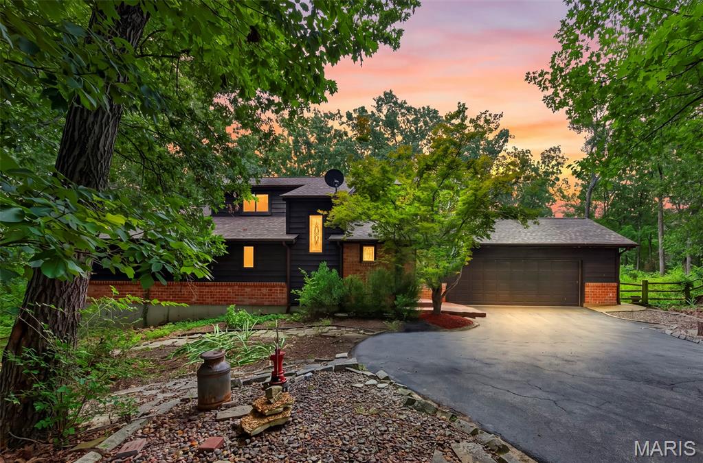 Welcome to 8 Rockwood Forest View. Tucked privately on 3 scenic acres in Wildwood and surrounded by mature woods, this distinctive home offers 4 bed, 3 and 1 half baths with approximately 3400 sf of living space on a peaceful, nature-filled retreat just minutes from everything. A serene koi pond with gentle water sounds and winding stone paths enhance the wooded setting, while a spacious new deck invites outdoor living and entertaining amid the trees.
Inside, the main level features a comfortable primary suite with a private bath that includes a soaking tub and separate shower. The kitchen showcases granite counters and a breakfast bar, opening easily to the living areas. A bright sunroom with walls of windows brings the outdoors in, complemented by beautiful stained-glass windows throughout. A convenient laundry room and half bath complete the main floor.
Upstairs you’ll find two additional bedrooms and a full bath. The large walk-out finished basement expands the living space with a wet bar, full bathroom, and a fourth bedroom—ideal for guests, a home office, or recreation—plus plenty of flexible room for a gym or media area.
Recent updates include a new roof (2024) and HVAC system approximately 6–7 years old. Enjoy the quiet seclusion of this home while still being close to parks, trails, and amenities. This is a rare opportunity to own a private, wooded sanctuary with modern comforts and timeless character. Welcome Home