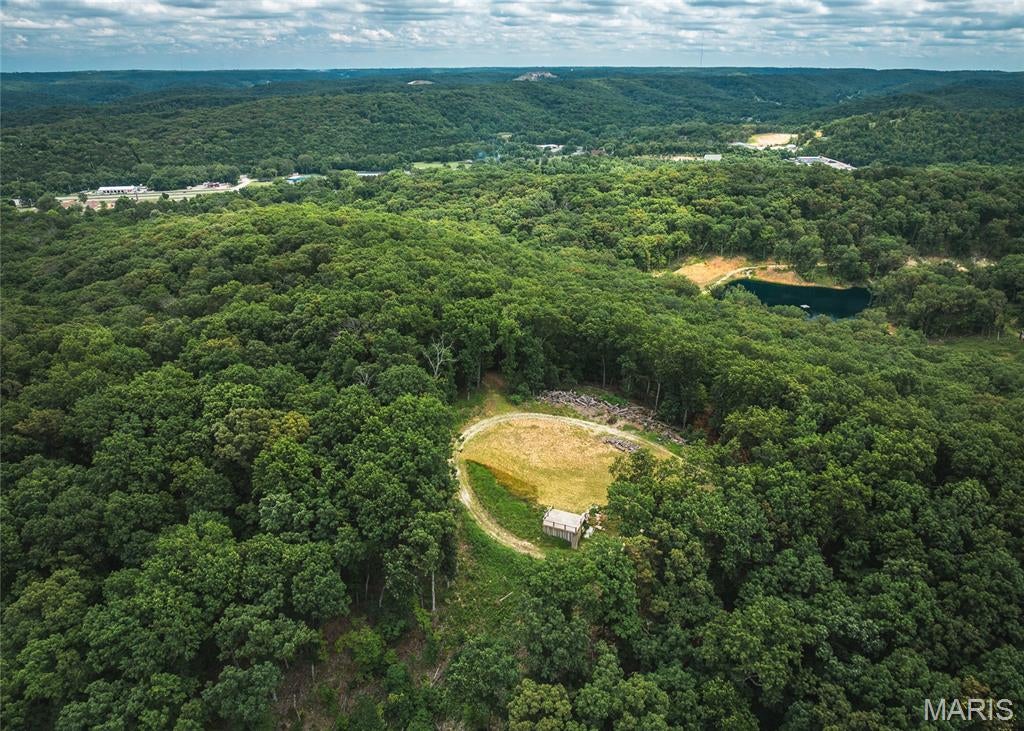 This 10-acre tract in House Springs, MO offers the perfect mix of seclusion and convenience. Nestled at the end of a private trail, the property boasts breathtaking views of the bottomland below and is just minutes from Highway 30—making for a quick and easy commute to St. Louis. A true outdoorsman’s paradise, the land is loaded with whitetail deer and wild turkeys, and is surrounded by larger tracts and landowners, keeping traffic minimal and wildlife plentiful. Whether you're looking to build your dream home, create a private hunting retreat, or simply enjoy a peaceful weekend getaway, this property checks all the boxes. It features mature, marketable timber, a small scenic clearing ideal for a cabin or campsite, and even includes a shipping container with an elevated observation deck—perfect for soaking in those classic Missouri sunsets or scouting your next hunt. Proof of funds or bank letter to be provided to agent to come take a look today! Multiple 10 acre tracts available!