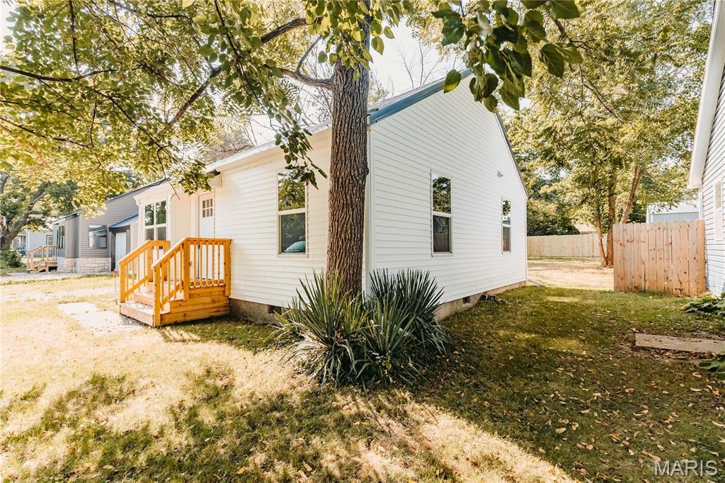 Completely renovated and move-in ready, this home offers updated finishes and functional living throughout. Recent improvements include vinyl siding, a black metal roof, luxury vinyl plank flooring, carpet, freshly painted concrete floors, drywall, paint, interior doors and trim, lighting, kitchen cabinetry, appliances, an updated bathroom, and a newly installed privacy fence enclosing the backyard. The open-concept living, dining, and kitchen areas create an inviting space for everyday living and entertaining. A spacious laundry room, conveniently located between the attached 1-car garage, kitchen, and backyard, provides additional storage and flexible space for coats, shoes, and everyday essentials. The attached 1-car garage features freshly painted concrete floors and offers convenient parking, storage, or workspace with direct access into the home. The updated windows provide abundant natural light, while the nicely sized backyard offers room to relax, entertain, or enjoy outdoor activities. This thoughtfully updated home blends modern finishes with everyday functionality and is ready for its next owner.