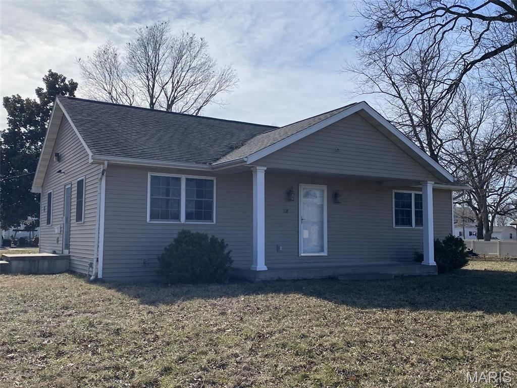 Well built and nicely maintained 2BR home on corner lot. Could also be commercial; buyer or buyers agent to verify with community for intended use. Large dine in kitchen and living room has an area for dining with a built in bookcase. There is a walk in closet between the two bedrooms. The full unfinished basement includes shelving and is roughed in for an additional bathroom. All 2 x 6 construction. The 1 car detached garage has alley access and there is additional parking available for several cars on the east side of the building with a ramp access. Nice corner lot in Bartelso. Lots of possibilities! Come make this one your own!