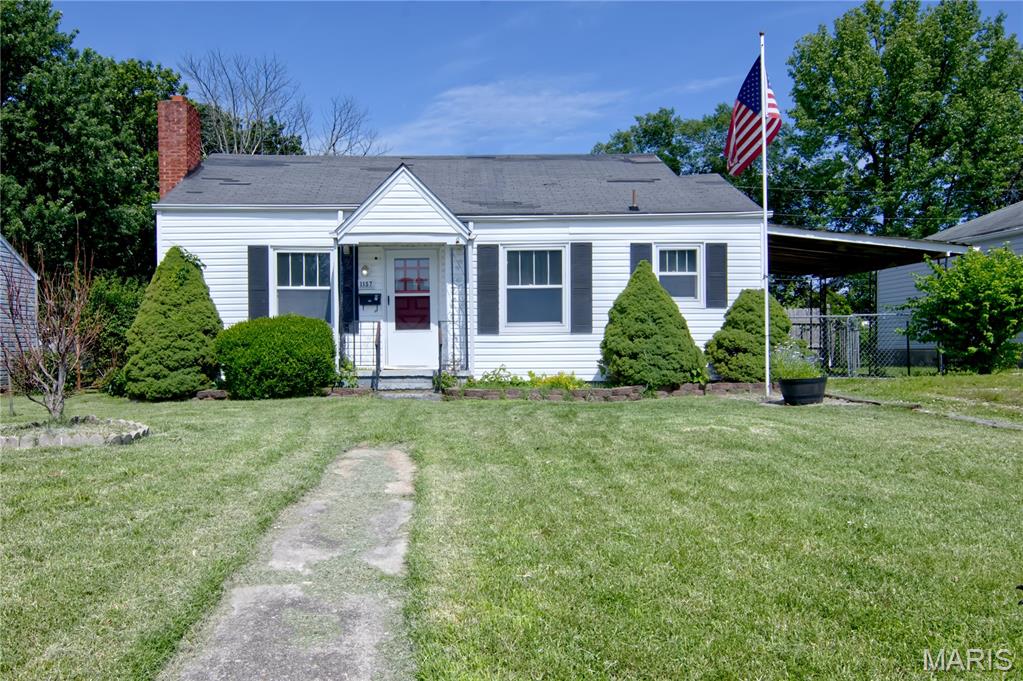 Charming Bungalow with Timeless Character and Exceptional Potential

This delightful bungalow offers a rare opportunity to restore and personalize a home rich in character and charm. From the moment you arrive, the property's attractive curb appeal is evident. Thoughtfully designed landscaping enhances the front yard, while a concrete walkway leads to a covered front porch and inviting red entry door.

Inside, you'll find original hardwood floors that showcase the home's classic appeal. The spacious living room features a fireplace as its focal point, creating a warm and welcoming atmosphere. Adjacent to the entry, the dining room continues the home's traditional character with matching hardwood flooring.

The rear of the home offers two comfortable bedrooms, a full bathroom, and a convenient hallway storage closet. One bedroom includes a generously sized walk-in closet, providing excellent storage space.

Outdoor amenities add both functionality and appeal. A covered carport offers protected parking and convenient access directly into the kitchen. The fenced backyard is beautifully accented with established perennial plantings and seasonal blooms, creating an inviting outdoor retreat. A charming workshop, thoughtfully designed to complement the home's exterior with coordinating paint and a matching red door, provides space for projects or hobbies. An additional metal storage building located behind the workshop offers ample room for equipment, tools, and extra storage.

Combining original architectural details, attractive outdoor spaces, and valuable outbuildings, this property presents an outstanding opportunity for homeowners, investors, or anyone seeking a home with character and potential.