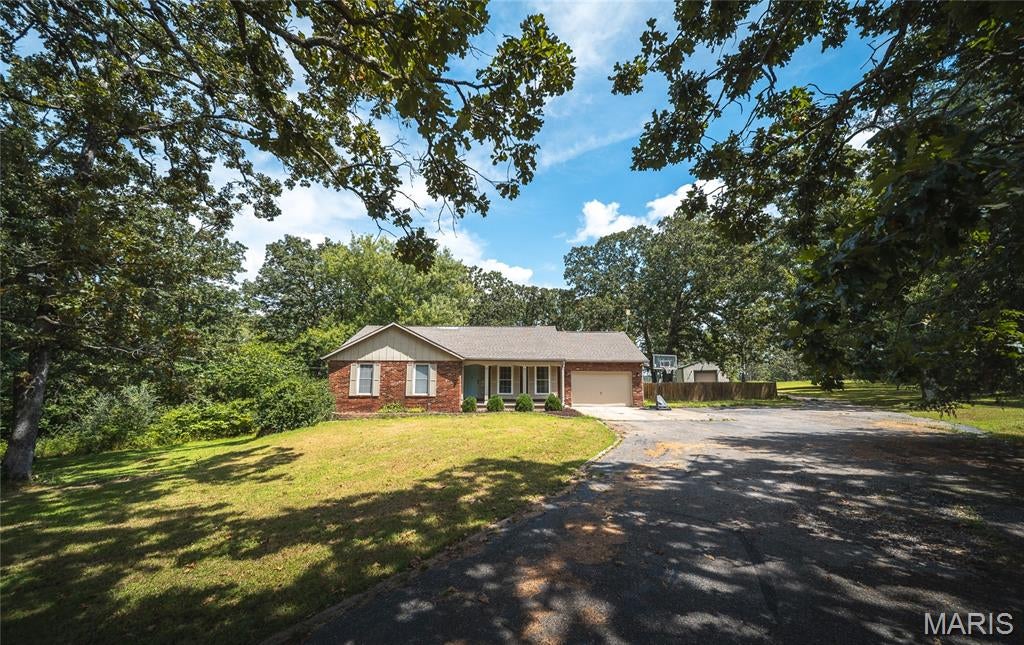 Tucked away on over 3 acres just outside of town, this charming 3-bedroom, 3-bathroom home offers the privacy and peaceful setting you’ve been looking for while keeping everyday conveniences within easy reach. Inside, the open floor plan creates a welcoming space for gathering and entertaining. The kitchen features a spacious island perfect for meal prep, casual dining, or catching up over morning coffee, while beautiful wood-beamed ceilings add warmth and character. The primary suite provides a relaxing retreat, complete with a beautifully designed shower that brings a touch of luxury to your daily routine. Step onto the screened-in deck and take in the serene surroundings, or head outside to your own private oasis. The in-ground pool is ready for summer afternoons, weekend gatherings, and quiet evenings at home, all surrounded by the space and privacy of your acreage. The finished basement adds even more flexibility with room for a game room, home office, additional living area, or entertainment space. You’ll also find a potential fourth non-conforming bedroom, offering additional options for guests or hobbies. A detached 22x24 shop/garage with electricity provides valuable space for vehicles, tools, projects, or extra storage. A new architectural shingle roof will be installed to provide excellent peace of mind. With acreage, a private pool, versatile living spaces, and plenty of character, this property offers a lifestyle that’s hard to beat. Schedule your private showing today and experience this peaceful retreat for yourself!