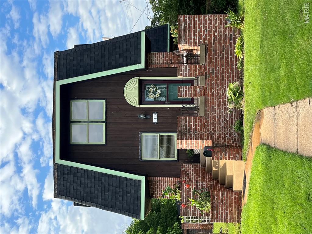This unique 2-story full-brick property is a rare real estate find, blending historic charm, recent modern updates, and a massive 5-car garage setup tailored for a contractor or hobbyist. Built on a triple lot originally as a boarding house, ensuring large, spacious rooms throughout. Features a large kitchen and family room extension built in 1972. Includes 3 bedrooms, a full bathroom with an attached dressing room, and a bonus walk-in closet between bedrooms. An outdoor oasis with a grand front porch, custom built in flower beds, a fenced side yard on an extra lot, and wrought-iron gate leading to a very private garden and covered walkway. Massive 5-Car Garage with 4 doors. Built for a contractor, offering a 3-car garage plus a 2-car carport with a double garage door. The final bay has a lower elevation to fit oversized or commercial vehicles and offers a dedicated electric panel.The Lower Level egress is a walk-out to the patio, a partially finished "rathskeller" and a roughed-in bathroom with shower. Recent Improvements include HVAC System, approximately 3 years old, New roofing shingles installed on the mansard roof, patio, and garage. Sewer replaced to the city main in 2025. Superb location, nestled in a highly walkable, vibrant neighborhood with easy access to local shops and dining. A semi-private alleyway provides direct access and is steps away from the Machacek Branch Library. See the floor plans in the photos. Do not miss this one-of-a-kind property! Agent related to seller.