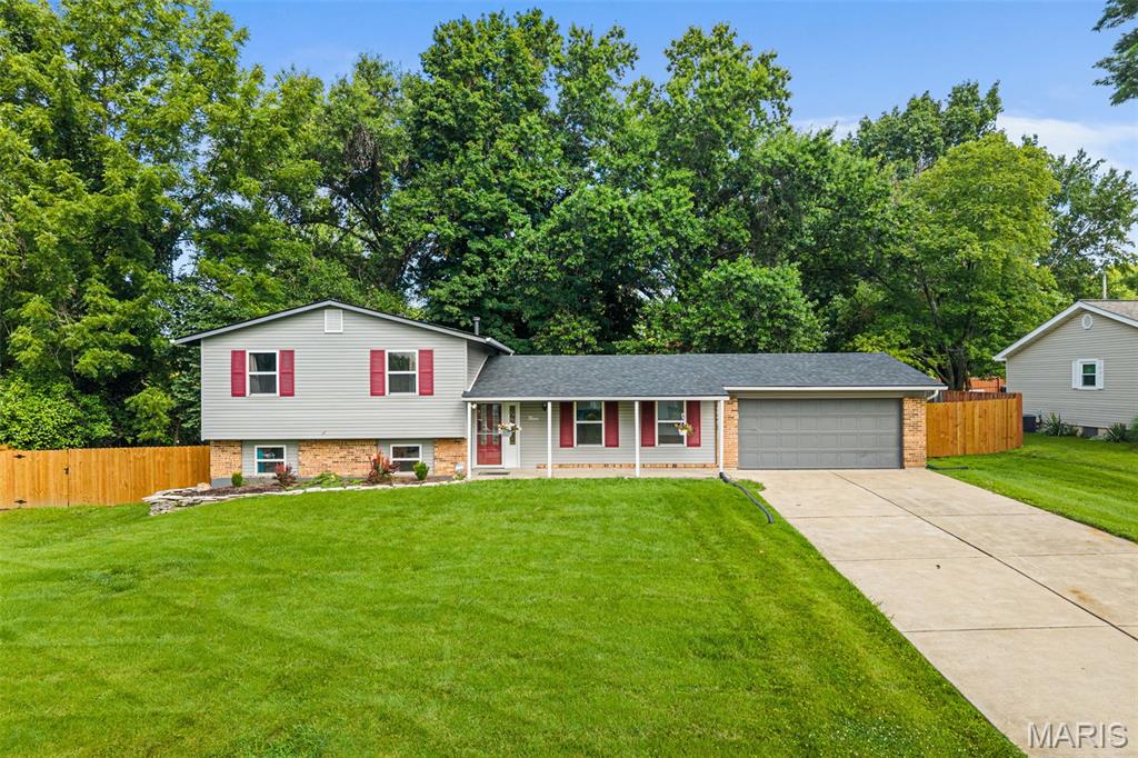 OPEN HOUSE 7/11 from 1-3PM. Welcome home to this beautifully remodeled tri-level offering 3 bedrooms, 2 full bathrooms, and just under 2,000 sq. ft. of stylish living space, all situated on a level lot of over half an acre in unincorporated St. Charles County! This move-in-ready home combines modern updates, thoughtful design, and plenty of room to spread out.

Step inside to an inviting open floor plan featuring luxury plank vinyl flooring, contemporary recessed lighting, elegant crown molding, and abundant natural light throughout. The stunning kitchen is a true centerpiece with custom cabinetry, gorgeous quartz countertops, tile backsplash, farmhouse sink, and brand-new stainless steel appliances. The refrigerator stays, making your move even easier!

The spacious primary suite offers plenty of room for a king-size bed and features a beautifully updated ensuite with a custom tiled walk-in shower. Both bathrooms have been completely renovated with custom tile surrounds, updated vanities, modern fixtures, and quality finishes. A convenient linen closet provides additional storage.

The professionally finished lower level adds valuable living space with a large family room, plus a bonus sleeping area or flex space perfect for guests, a home office, or hobby room.

Major exterior improvements include maintenance-free siding, energy-efficient windows, a high-efficiency top-of-the-line HVAC system, a 7-month-old architectural shingle roof, and a sewer liner installed by the previous owner for added peace of mind. The oversized 2-car garage offers ample storage and workspace.

Outside, enjoy your own private retreat featuring a pergola, mature pear trees, Dutch storm doors, and a privacy fence with a gated entrance along the front of the property. AT&T Fiber internet is available, providing fast, reliable connectivity for work or entertainment.

Offering modern updates, generous living space, and a fantastic location close to shopping, dining, and major highways, this home truly checks all the boxes. Schedule your private showing today—this one is sure to impress!