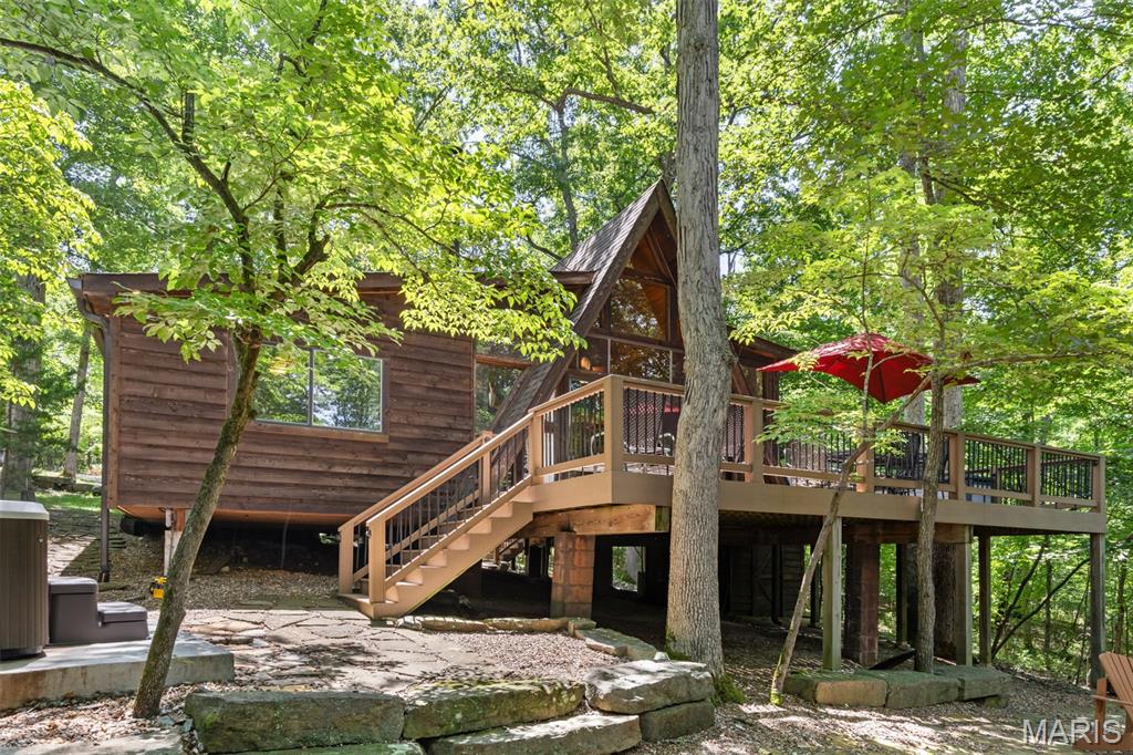 A chalet of this quality is so rare—you truly must see it to believe it. Offering the perfect blend of luxury, comfort, and low-maintenance ownership, 632 Wunderbar presents an exceptional opportunity to enjoy the Innsbrook lifestyle while maximizing relaxation and rental potential. Completely renovated inside and out, this turnkey chalet showcases exceptional craftsmanship, thoughtful design, and high-quality materials throughout. The extensive renovation included a primary bedroom addition, great room remodel, new cedar walls and ceilings, updated electrical and plumbing systems, new flooring, bathrooms, lighting, windows, doors, roof, gutters, and more. A complete list of improvements is available, as the scope of updates is simply too extensive to capture here. Inside, every detail has been curated to create a warm and inviting atmosphere that perfectly balances classic cabin-in-the-woods charm with light, sophisticated finishes. The main level features a stunning stone masonry dining area, spacious kitchen, and great room anchored by a raised-hearth, wood-burning stone fireplace. Two bedrooms, including a primary suite and bunk room, plus a full bath complete the main floor. Upstairs, the loft offers additional sleeping space and a half bath. Comfortably sleeping up to 12 guests, this chalet is ideal for family gatherings, weekend retreats, and short-term rental income. Outside, professionally landscaped and terraced grounds surround a custom stone patio with fire pit, composite deck, and newer hot tub overlooking the woods. A newly constructed shed and additional storage/workshop space beneath the chalet provide ample room for outdoor gear and equipment. Private trails weave through the woods, creating the perfect setting to enjoy nature right outside your door. This chalet is a MUST SEE!!