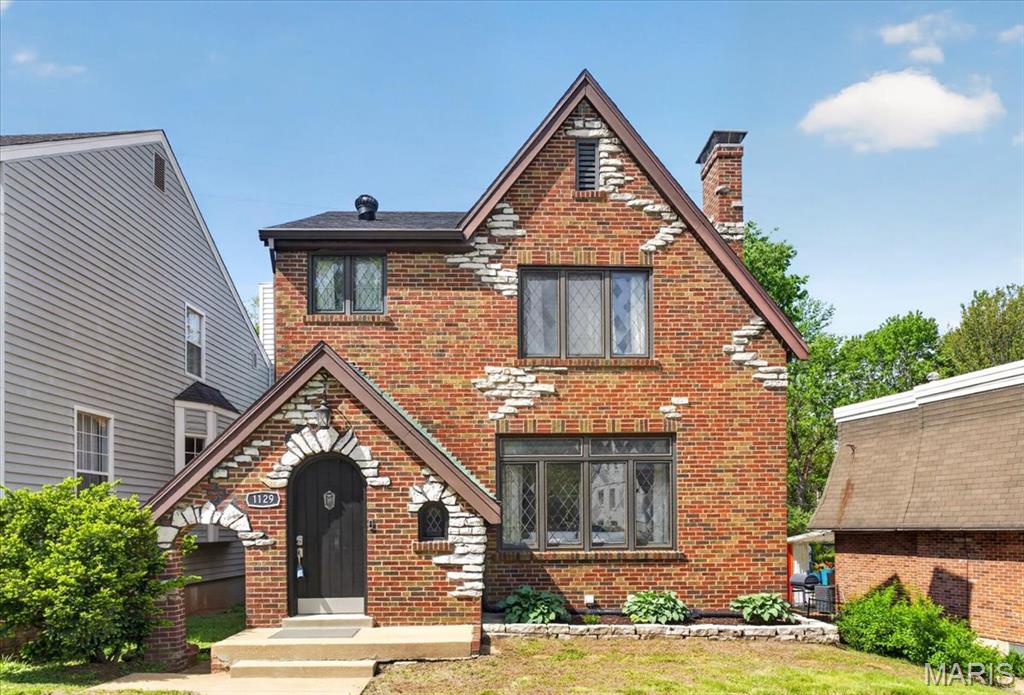 In the heart of Richmond Heights and the highly rated Clayton School District, this storybook 2.5 story Tudor blends timeless architecture with fresh modern flair. Arched doorways, hardwood floors, and two fireplaces set a warm, welcoming tone, while designer lighting and rich textures bring every room to life.  The chef’s kitchen wows with deep burgundy cabinetry, granite counters, and stainless appliances—open to the dining and sitting areas, perfect for cooking, conversation, and gatherings. Upstairs, you’ll find two spacious bedrooms plus a flexible top-floor retreat ideal as a 3rd bedroom, studio, home office, or guest space. Updated baths feature artful tilework, a copper vessel sink, and vintage-meets-modern style.  Enjoy morning coffee on the screened porch overlooking the fenced backyard oasis. From its arched-top front door to its new (2025) roof, this one-of-a-kind Tudor offers character, comfort, and convenience close to highways, parks, shops, and great restaurants.