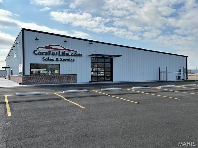 Positioned along Interstate 55 in Scott City, this rare 5-acre industrial outdoor storage (IOS) facility offers a turnkey opportunity for fleet, equipment, or service-based users seeking visibility, functionality, and scalability. The property features two high-quality buildings totaling approximately 24,800 SF, including a 15,000 SF fully conditioned shop/warehouse and a 9,600 SF modern showroom/office facility built in 2023. The shop includes 16’ clear heights, overhead doors, and dedicated office/support areas, making it ideal for maintenance, service, or light industrial operations.

The site is fully fenced and secured with three access gates and offers a rare combination of 5 acres of paved yard allowing for immediate use by truck fleets, equipment operators, or outdoor storage users.

Strategically located near the Nash Road interchange, the property provides direct interstate access and is in close proximity to the Cape Girardeau Regional Airport and SEMO Riverport, enabling efficient regional and national distribution.

This is a unique opportunity to acquire a highly functional, move-in-ready facility in a supply-constrained asset class with strong demand from logistics, construction, and industrial service users.
