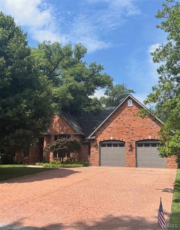 Welcome to this exceptional full-brick, raised ranch, where architectural elegance and custom, upgraded construction meet modern luxury. Designed with dramatic space and entertaining in mind, this residence pairs grand spaces and clever, functional design. Soaring vaulted ceilings and a breathtaking wall of windows flood the home with natural light. A striking atrium floating staircase anchors the living space and flows seamlessly into the hearth room, which features a gas fireplace, a covered balcony, and a separate dining area. The chef's kitchen features premium finishes and high-end appliances. A private sanctuary featuring two separate en-suite bathrooms and two spacious closets. A dedicated main-floor laundry streamlines your daily routine. The entertainment-ready walk-out lower level features a massive living area, a custom wet bar, a private guest bedroom, and a full bathroom. Prioritize health and safety with a dedicated exercise room with tons of natural light, a private sauna, and even a secure safe room. There is plenty of storage in the unfinished workshop, and a hidden staircase leads to the attached oversized garage. A peaceful, private outdoor retreat is perfect for relaxation. 
So much more information on the custom, upgraded construction and amenities! 
Professional pics coming soon!