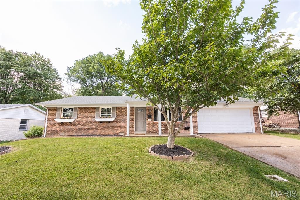 Welcome to 117 Williamsburg! This beautifully updated 3-bedroom, 1.5-bath all-brick ranch offers easy one-level living with plenty to love inside and out. The spacious family room features LVP flooring that continues through the kitchen and dining area, while the bedrooms offer beautiful hardwood floors. Updates throughout give the home a fresh, move-in-ready feel. Just off the kitchen and dining area, step outside to the covered back patio overlooking the fully fenced backyard—perfect for relaxing, entertaining, or letting the kids and pets play. The landscaped brick firepit area provides another great spot to gather with friends and family. Additional highlights include a 2-car attached garage, new AC unit, fully encapsulated crawl space, and leased solar panels. With its classic brick exterior, thoughtful updates, comfortable layout, and inviting outdoor spaces, 117 Williamsburg is ready to welcome you home!