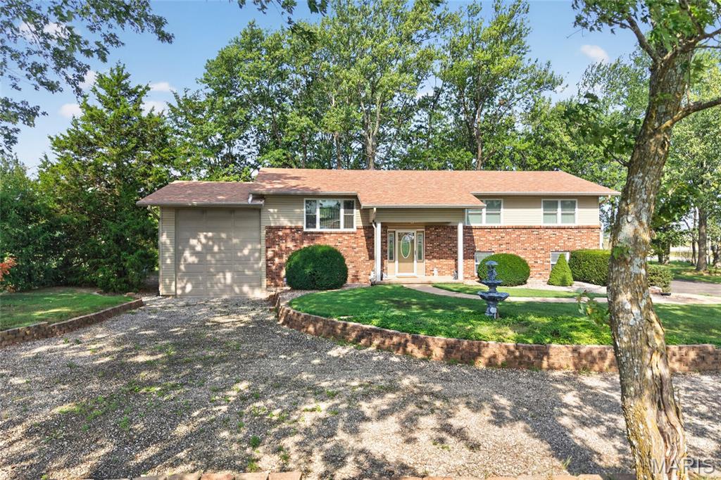 Welcome to a truly special home that has been lovingly cared for by the same owner for more than 40 years. Nestled on the south side of town in a beautiful park-like setting, this meticulously maintained split-level home offers the perfect combination of space, convenience, and timeless charm. Featuring 4 bedrooms (possibly 5) and 3 full bathrooms, there is plenty of room for family, guests, hobbies, and everyday living. Beautiful crown molding throughout the home adds an elegant touch and complements the home’s timeless character. The sunroom surrounded by windows creates a bright and inviting space to relax while taking in the peaceful park-like surroundings. If the John Deere room, outdoor shed and multiple garages aren't enough space for all of your storage needs—there is an impressive, oversized 35’ x 14’ garage with a 12-foot door perfect for an RV, boat, or recreational equipment. Situated on over an acre, the property offers a peaceful, spacious setting while remaining conveniently close to I-44, hospitals, restaurants, shopping, and other amenities. Adding even more peace of mind, the home received a brand-new roof in July 2026. After more than four decades of love and care, this property is ready for its next chapter. If you’re looking for a spacious home with timeless character, an exceptional setting, abundant storage, and convenient access to town, this one is a must-see!