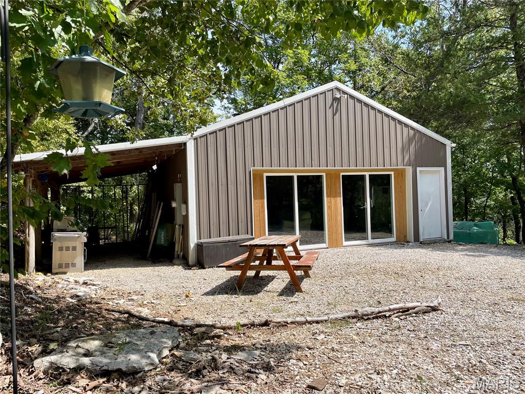 Do you enjoy camping or having a place to gather with family and friends? 

This Private Peaceful 7.5 acres sits at the top of a hill with a beautiful view of Lake Pinnacle.  A gated entrance drive leads to a large, level, cleared area with a 24x22 metal building which is insulated & has electric, a wood burning stove, heaters, an AC window unit & a large fan that convey with property. The building has a poured concrete floor, bathroom, & kitchenette. The kitchenette has a refrigerator, stove & sink which is set up to use fresh water brought in from the water trailer. There is a septic holding tank & 1,100 gallon water tank to service the bathroom. Use your imagination and build what you wish on the existing 28x20 foundation. Lake Pinnacle is a private gated community with a 130 acre spring fed Lake perfect for fishing, boating, swimming, hunting, trail riding & endless amounts of fun year round. Community amenities include a beach & swimming area, pavilion, play ground, tennis courts & boat docks. Campers allowed for recreational use.

Don’t miss out on this incredible getaway!!