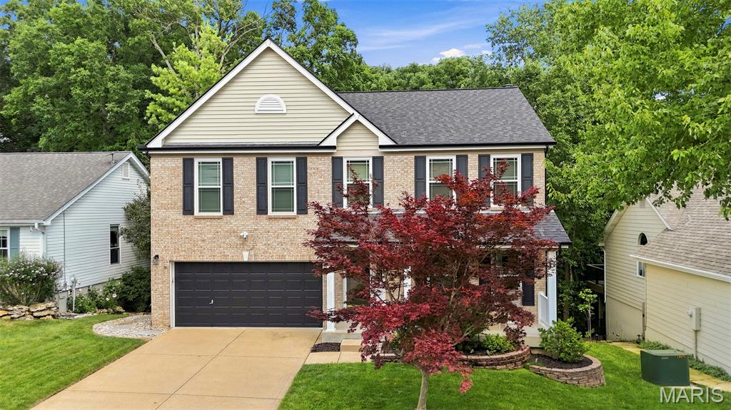 Fantastic 2-Story home on quiet cul-de-sac street featuring a covered front porch, brick front and major updates throughout in the sought-after Westbrooke Woods subdivision. Boasting 4 bedrooms, 3.5 bathrooms, 3,374 sqft of total living space, and a 2-car garage. 
The main level features an open floor plan with engineered hardwoods upon entry leading into an office with built-in cubbies, crown and casement moldings. Inviting great room offers recessed lighting and a wood-burning fireplace with a brick mantle flanked by built-in cabinetry. Designer kitchen complete with 42-inch soft-close cabinetry w/crown, quartz countertops, under-cabinet lighting, a striking waterfall island, custom hexagon backsplash, full extension pull out drawers, commercial grade gas range with hood, newer stainless appliances and walk-in pantry. The adjoining breakfast room walks out to a composite deck that backs to serene common ground and woods. Main floor laundry with cabinetry and LG washer/dryer, updated powder room with Hunter Green vanity and quartz counter. 
Spindled stairwell leads to upper level, which features brand new carpet throughout. Luxurious primary suite includes a walk-in custom closet, raised Hunter Green dual vanity/towers, built-in power outlets, quartz counters, lit mirror, private water closet with bidet and custom walk-in shower. Three additional large bedrooms all feature walk-in closets and share an updated hall bath with Navy cabinet and ceramic flooring. 
Finished walk-out lower level includes a living room with built-in cabinetry and recreation room with kitchenette and a full bathroom. Other features include: Roof & Gutters(2025), Water Heater (2021), Vinyl Double-Hung Windows, Carpet/Paint(2026), Landscape Lighting, Irrigation System and EV charger in garage! Highly-rated Rockwood School District, Ballwin Amenities, Walking Distance to Bluebird and Castlewood State Park!
