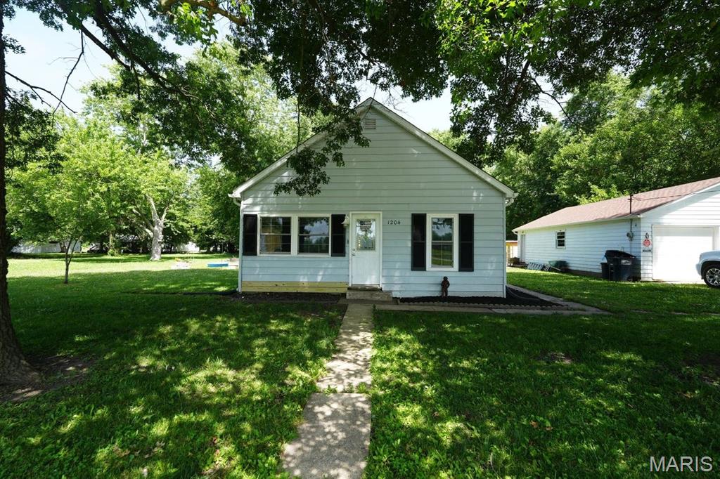 Welcome home to this charming 2-bedroom, 1-bath cottage situated on a spacious 3/4-acre corner lot on the edge of town. This move-in-ready property offers the perfect blend of modern updates, outdoor space, and small-town living.
Step inside to discover updated laminate flooring and an inviting open-concept living and dining area that creates a bright, welcoming atmosphere. The updated kitchen features a center island, ample cabinet space, and a functional layout that's perfect for everyday living and entertaining. Convenient main-floor laundry adds to the home's practicality.
Both bedrooms are generously sized and offer large closets, providing plenty of storage. Whether you're a first-time homebuyer, looking to downsize, or searching for a cozy retreat, this home is ready for you to move right inOutside, you'll appreciate the detached two-car garage, a private backyard with a relaxing patio, and plenty of room to enjoy the outdoors. The expansive lot currently accommodates small farm animals, offering flexibility for hobby farming, gardening, or simply enjoying the extra space.
Located across from a neighborhood park and near beautiful Shale Lake, this property combines peaceful living with convenient access to recreation and town amenities. Don't miss your opportunity to own this delightful cottage with room to grow!
