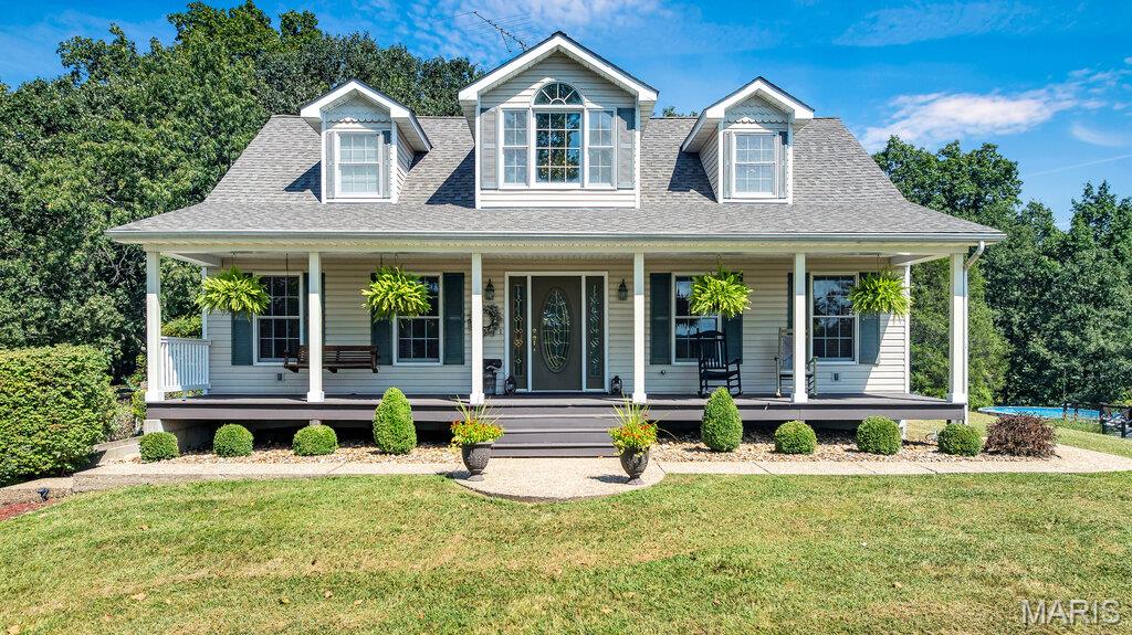If you have been waiting for that one of a kind property to come available in the Hermann area, this is the ONE! Nestled on 12.25 picturesque acres along Highway 100, this exceptional custom-built home offers the perfect blend of privacy, rural charm and zero restrictions! The property features rolling pastureland, a small pond, mature woods, and a beautiful hilltop setting that places the home well off the road, creating a peaceful and secluded atmosphere.
Built in 1996 and meticulously maintained, this one-owner home showcases quality craftsmanship throughout. From the custom hardwood flooring and handcrafted cabinetry to the detailed millwork and thoughtful design, every room reflects pride of ownership and timeless appeal.
Offering over 3,000 square feet of finished living space, the home features four spacious bedrooms, three full bathrooms, and one half bath. The main level and upstairs living space includes approximately 2,200 square feet of living area, while the finished basement adds an additional 800 square feet, providing ample room for entertaining, recreation, or guest accommodations.
The inviting living room is centered around a warm gas fireplace, creating the perfect gathering space for family and friends. Abundant storage can be found throughout the home, ensuring functionality matches its beauty. Recent updates include a new roof and furnace, providing peace of mind for years to come.
Outdoor living is equally impressive. Relax on the expansive covered front porch that stretches the full width of the home and offers stunning views of the surrounding countryside. The beautifully landscaped grounds enhance the home's curb appeal, while the oversized two-car attached garage provides convenience and additional storage. A private hot tub patio creates the perfect place to unwind after a long day, and the lower level features an additional one-car garage ideal for lawn equipment, hobbies, or workshop space.
In the large backyard, summer enjoyment awaits with the large above-ground pool surrounded by a custom maintenance-free deck, while raised garden beds are ready to be planted. 
Whether you're seeking a full-time residence, a weekend escape, or a property where you can start your own hobby farm, this remarkable Hermann-area estate delivers unmatched quality, comfort, and natural beauty. Don’t sleep on this one!