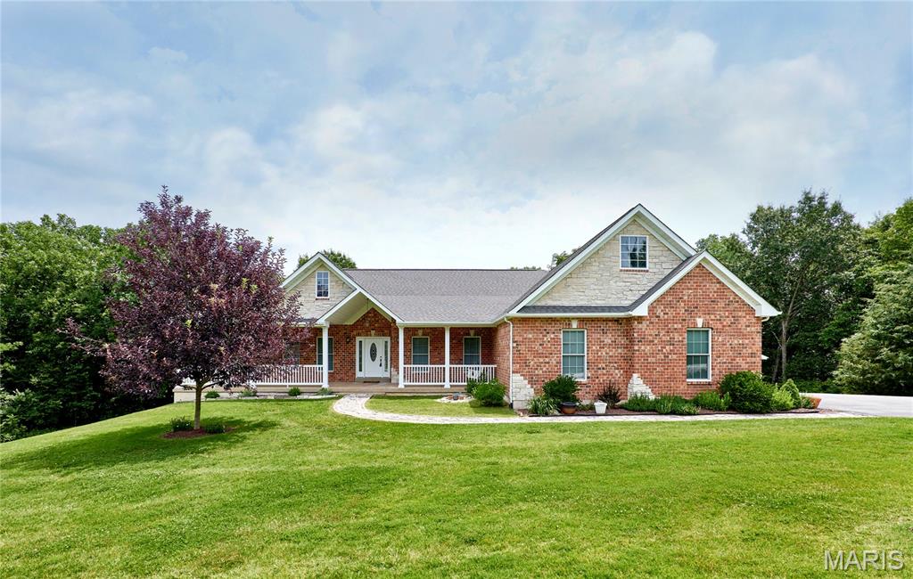 Welcome home to your own private retreat! Nestled on 4 picturesque acres, this spacious 5-bedroom, 3-bathroom home offers over 4,500 square feet of finished living space and the peace and tranquility you've been searching for. The heart of the home is the well-appointed kitchen featuring a large center island, abundant cabinetry, and plenty of countertop space for cooking, entertaining, and everyday living. Just off the kitchen, the separate dining room provides the perfect setting for family meals and holiday gatherings. The inviting family room offers a cozy fireplace and beautiful views of the surrounding countryside. The thoughtfully designed main level features a spacious primary suite complete with a private en suite bathroom and two walk-in closets. Two additional bedrooms and a full bathroom complete the main floor, offering the convenience of main-level living. The finished walkout lower level provides exceptional additional living space with a large family room featuring a wood-burning fireplace, making it the perfect place to relax or entertain. This level also includes two additional bedrooms, a full bathroom, and a versatile bonus room ideal for a home office, playroom, fitness room, hobby space, or whatever best suits your lifestyle. Walk directly out to the backyard and enjoy the peaceful surroundings. Step outside and experience the beauty of country living with 4 private acres offering endless opportunities for recreation, gardening, or simply enjoying the serenity of nature. Car enthusiasts, hobbyists, and those needing extra storage will appreciate the oversized 2-car attached garage along with the impressive 30' x 24' outbuilding, perfect for a workshop, equipment, recreational vehicles, or additional storage. As an added bonus, all kitchen and laundry appliances stay with the home, along with the basement safe, making your move even easier. If you've been dreaming of a property that offers generous living space, incredible flexibility, and the peace of country living without sacrificing modern conveniences, this exceptional home is one you won't want to miss!