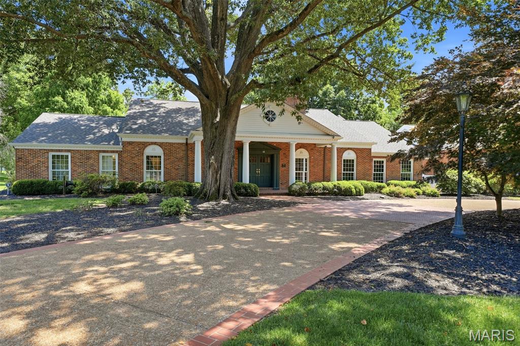 A rare offering in the heart of Ladue, this extraordinary 6-bedroom, 8-bath estate represents the perfect union of timeless architecture & exceptional modern luxury. Set on nearly 1.8 acres of level, park-like grounds, the residence has been comprehensively transformed through a meticulous designer-led renovation, where every finish, fixture, texture, & detail was thoughtfully selected to create a home of remarkable beauty, comfort, & enduring quality.

A dramatic foyer welcomes guests with soaring ceilings & original brick flooring, setting the tone for a home that effortlessly balances historic character with sophisticated design. The great room is bathed in natural light & anchored by a stately fireplace, creating an elegant yet inviting gathering space. Just beyond, the formal dining room is wrapped in designer wall coverings & offers a stunning backdrop for intimate dinners & grand celebrations alike.

The chef's kitchen is a true showpiece, designed for both everyday living & exceptional entertaining. Premium appliances, an oversized center island with farmhouse apron-front sink, bespoke cabinetry & designer hardware, scalloped glass accents, extensive pantry storage, refrigeration drawers, & a fully appointed butler's pantry create a space that is as functional as it is beautiful. The adjoining hearth room, featuring original brick floors & a sophisticated wet bar, offers a warm & inviting atmosphere while maintaining the thoughtful delineation of a classic floor plan.

The main level offers three generously sized bedrooms, including a private guest suite featuring a luxurious bath with a curbless shower & abundant natural light. Two additional bedrooms are thoughtfully connected by a beautifully renovated Jack-and-Jill bath, creating an ideal balance of comfort & functionality.

Privately positioned in its own secluded wing, the primary suite is a true retreat. Vaulted ceilings, a fireplace, & a private sitting area create a serene escape, while a custom dressing room leads to an extraordinary spa-inspired bath featuring a stunning wet room, freestanding jetted soaking tub, & designer finishes.

One of the home's most enchanting spaces is the richly appointed library, complete with floor-to-ceiling bookcases, dramatic colors, custom lighting, & a fully equipped bar. Equally suited for reading, entertaining, work, or play, it is a space unlike any other.

The upper level features an elegant landing/sitting room flanked by two additional bedroom suites, each with beautifully renovated private baths & walk-in closets.

Designed with wellness and recreation in mind, the walk-out lower level offers flexible fitness and gathering spaces, a steam room, sauna, built-in lockers, & generous wine storage. A massive, heated five-car garage provides exceptional storage, workshop space, & versatility.

Outdoors, the resort-inspired saltwater pool has been comprehensively re-engineered with all-new systems, equipment, finishes, & mechanicals, delivering the experience and performance of a newly constructed luxury pool. Thoughtfully designed for both grand entertaining & everyday enjoyment, the outdoor spaces serve as a natural extension of the home, creating a lifestyle centered around connection, comfort, & effortless indoor-outdoor living.

A full-sized elevator ensures effortless accessibility & convenience for years to come. Sophisticated yet welcoming, bold yet timeless, this remarkable estate honors its traditional roots while embracing elevated contemporary living. Just moments from premier schools, private clubs, shopping, dining, & convenient highway access—with exclusive resident-only access routes enhancing both connectivity & privacy—this is a truly exceptional opportunity in one of St. Louis' most prestigious communities.