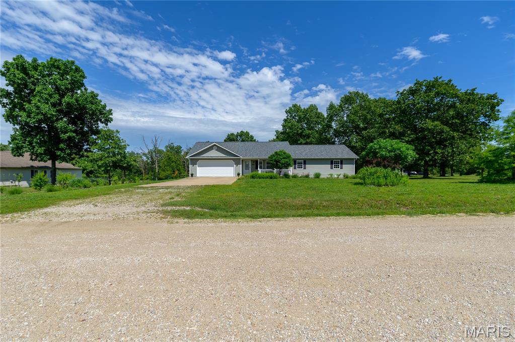 Immaculate country home sitting on 1+ acres of privacy with tons of updates!  Brand-new roof in 2025, gorgeous new flooring throughout the home, and a new deck that includes a gazebo!  This 3-bedroom, 2-bath, 2-car garage offers a stunning fireplace in the living room, a flexible bonus room perfect for a formal dining room, private home office, or a secondary family room, a large kitchen with tons of countertop space, cabinets, and a breakfast bar, a master suite with 2 closets, a double vanity, and a jetted tub.  Step outside to a beautiful private backyard featuring vibrant wildflowers and a charming outdoor gazebo perfect for reading.  Fire up the grill on your brand-new back deck, grow your own vegetables, get the chickens you've been wanting, enjoy games and activities, there's tons of usable land to work with!  Schedule your showing quickly- this one won't last long!