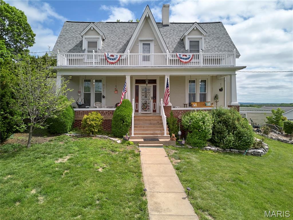 Gracefully placed on a bluff above the majestic flowing Mississippi River is this Victorian treasure where from the overlook deck you can listen to the gentle hum of the towboats coming down river, the soft splash of the river waves along the shoreline, the sound of the soaring eagle flying above, and the whistle of the distant train as it enters town.  The Great River Road B & B also known as the Lafayette Tinsley Home Circa 1870 offers a unique blend of historical character and contemporary living with its 6 bedrooms and 4 1/2 bathrooms. Invision the many possibilities from multigeneration living, expansive mother in-law suite, a rental apartment and so much more. The updated kitchen is designed for both culinary exploration and social gatherings with an amazing view. It features elegant stone counters and a functional island with farmhouse sink, updated appliances, and creates an ideal space for meal preparation and casual dining. Cypress and oak fretwork, original oak flooring, Bohemian glass on the front doors, leaded glass in upstairs door, ornate antique light fixtures, glass French doors, and expansive ceiling height enhance the character of this amazing home. Two bedrooms can be utilized on the main floor with four additional on the second floor.  A panoramic view can be seen from the front and back balconies off the second level.  Two full and one-half baths are located on the main floor with two full on the upper level to accommodate a large family or many guests. Tranquil and serene enjoyment from the charming front porch, the screened back porch, or the overlook deck. Beautiful landscaping blooms throughout the seasons.  This home offers an attached 2 car garage and additional parking pad.  Schedule a visit to see the many more details.